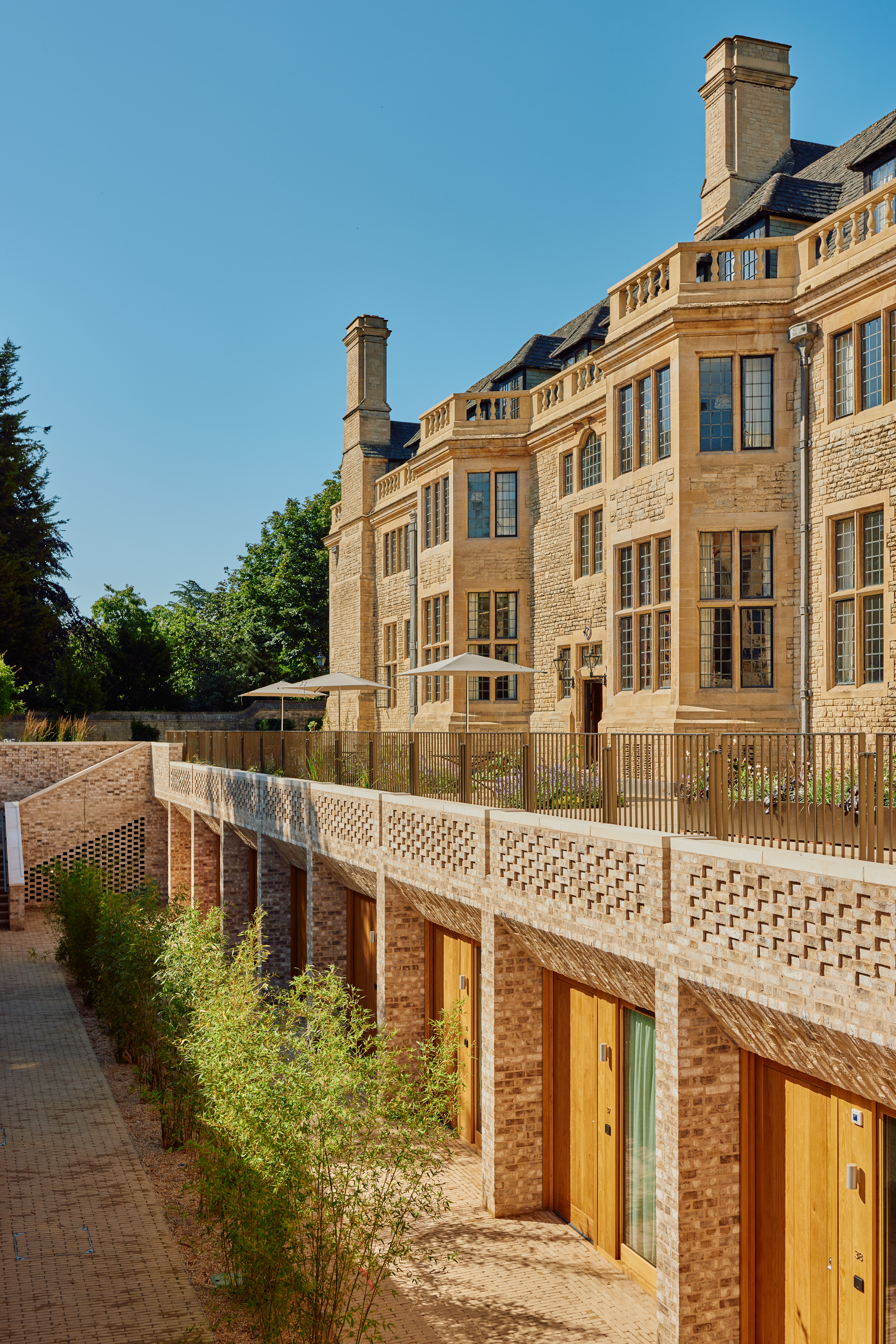 View of the Rhodes House Oxford courtyard accommodation and east wall of Rhodes House in sunshine