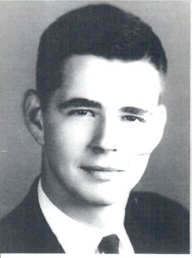 A black-and-white headshot of Norton