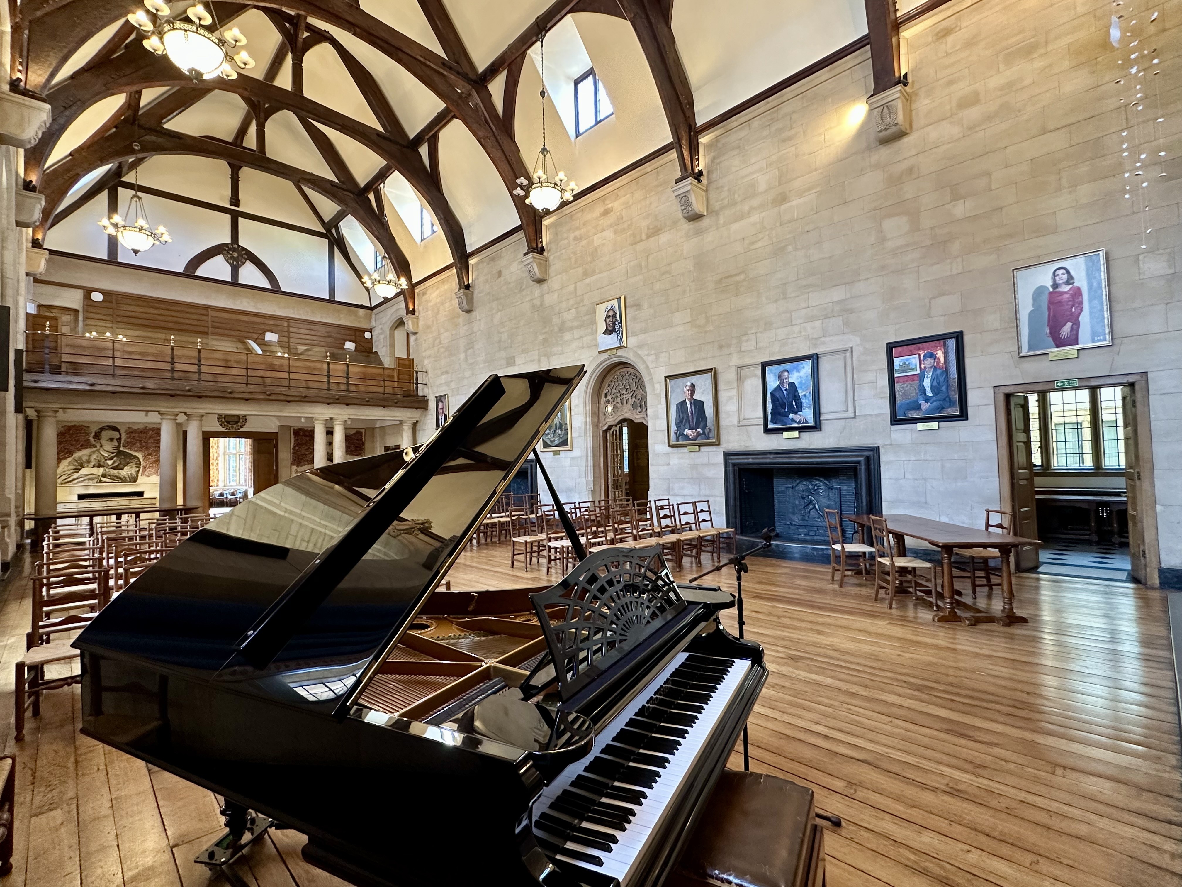 Rhodes House McCall MacBain Hall set up for a wedding ceremony with chairs, with grand piano in the foreground.