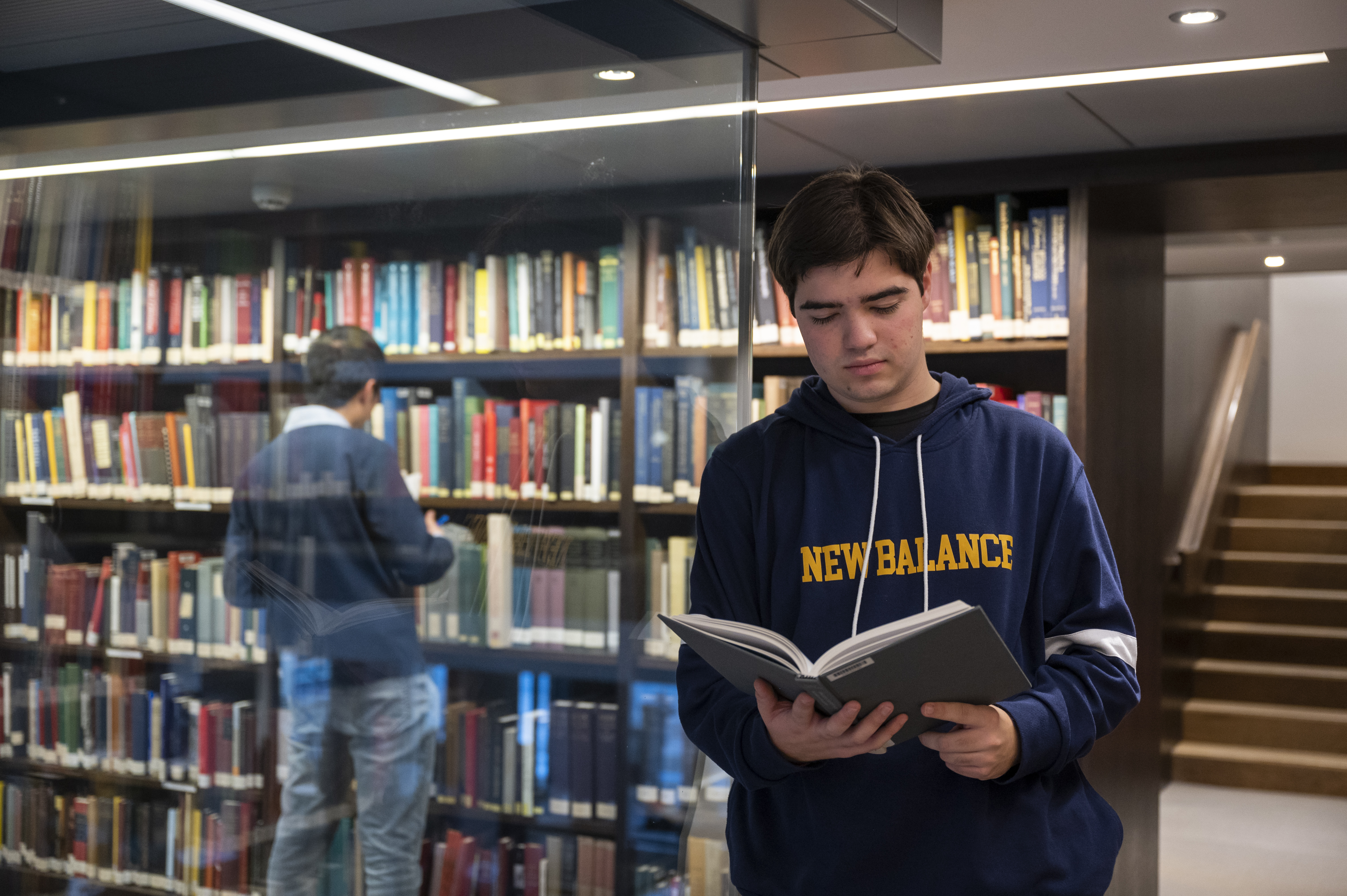 Scholar holding a book open and reading