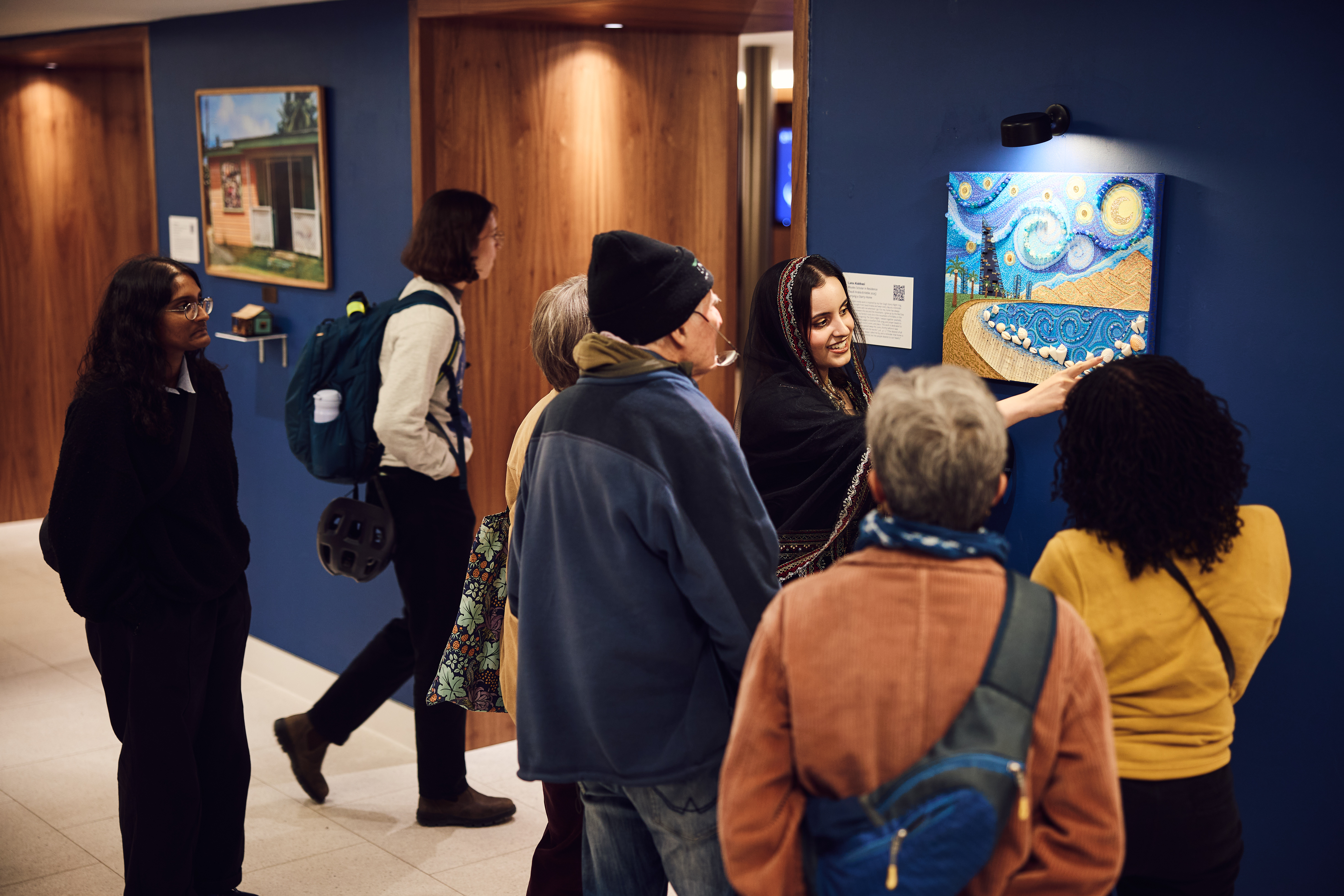 Lana showing her artwork to a crowd