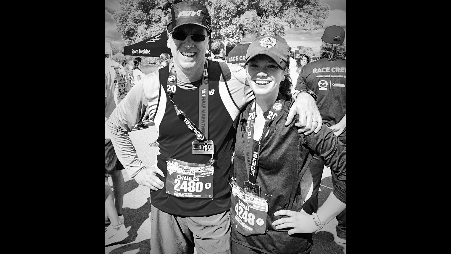 Charles and Sarah with hats on and stickers on their t-shirts as part of a half marathon 