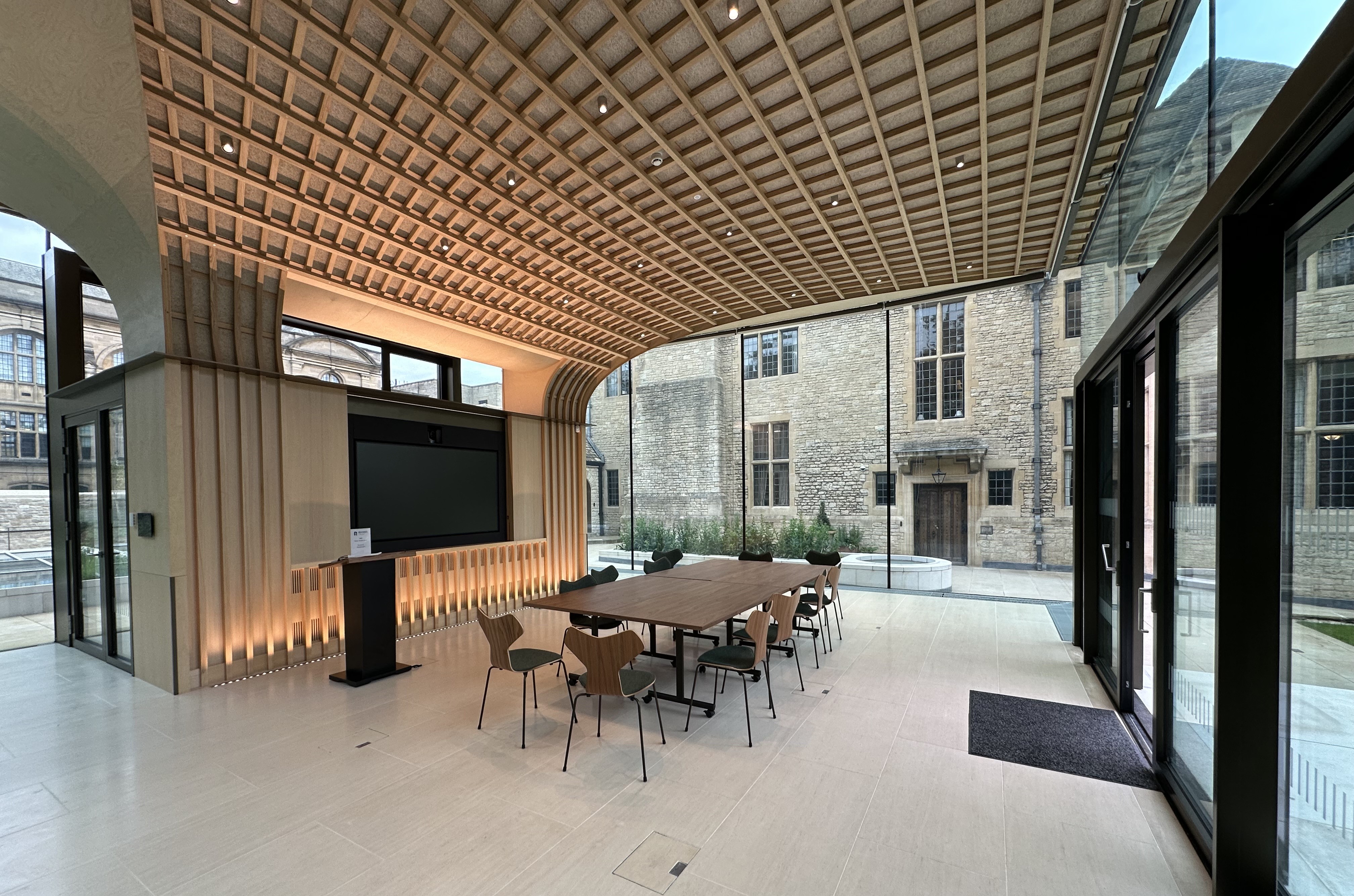 Inside view of the Rhodes House Glass Pavilion set up for a boardroom meeting