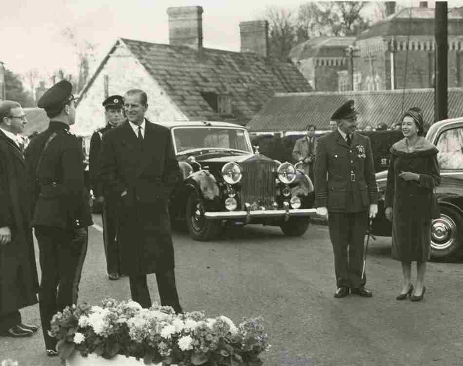 Black and white photo depicting the Queen and Prince Philip arriving at Rhodes House in 1963.