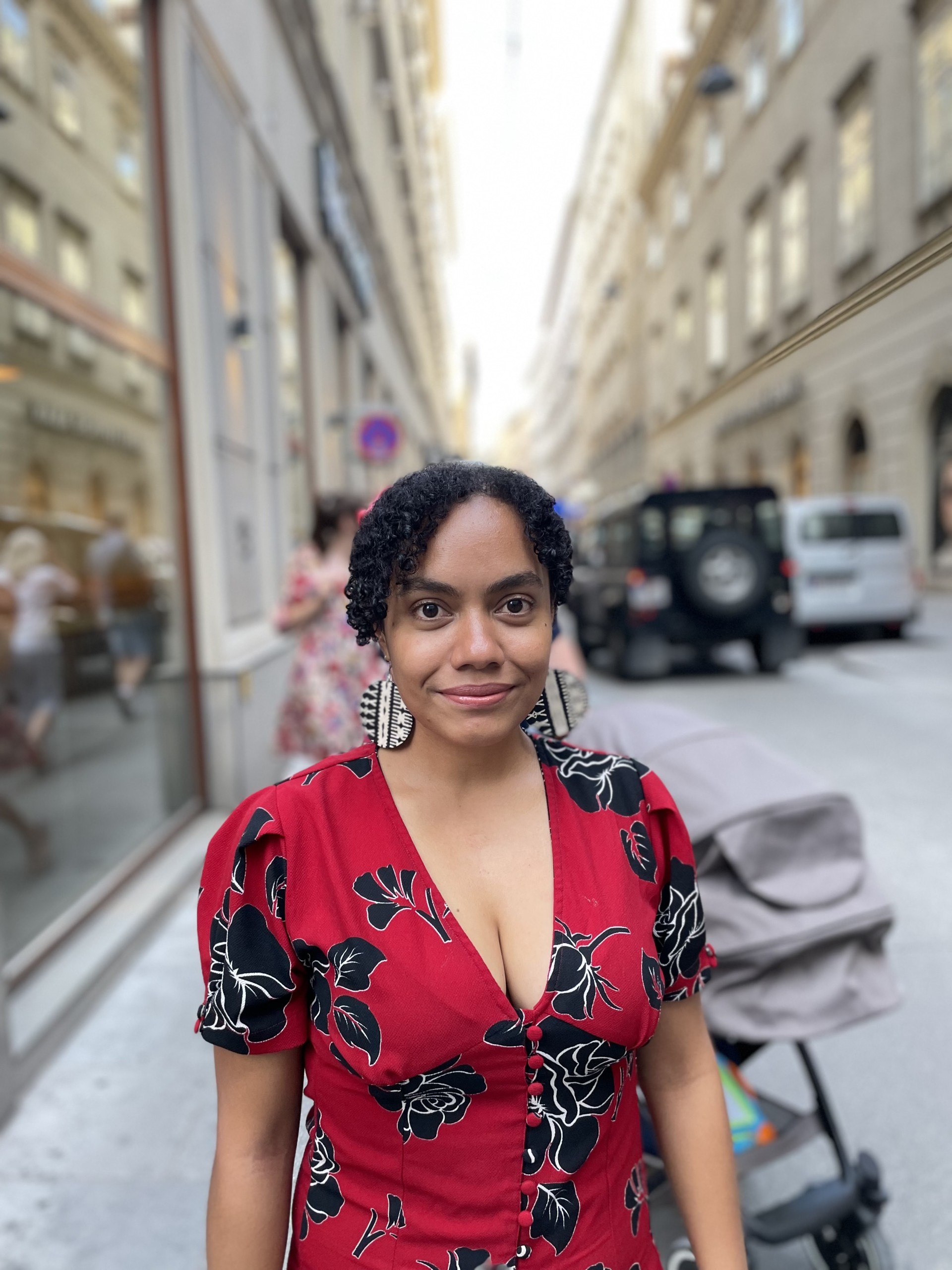 Talei standing on a street with tall buildings in the background