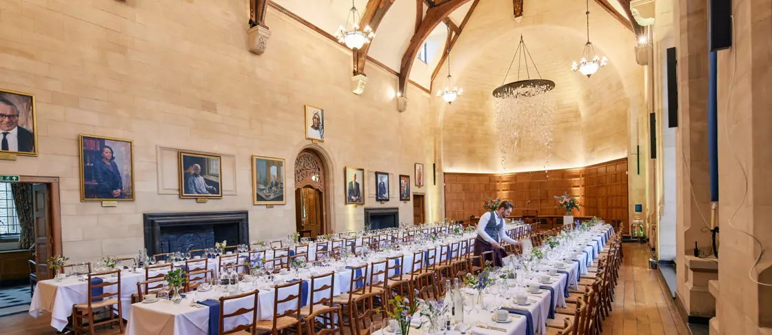 Image of hall with tables set and laid out for dinner