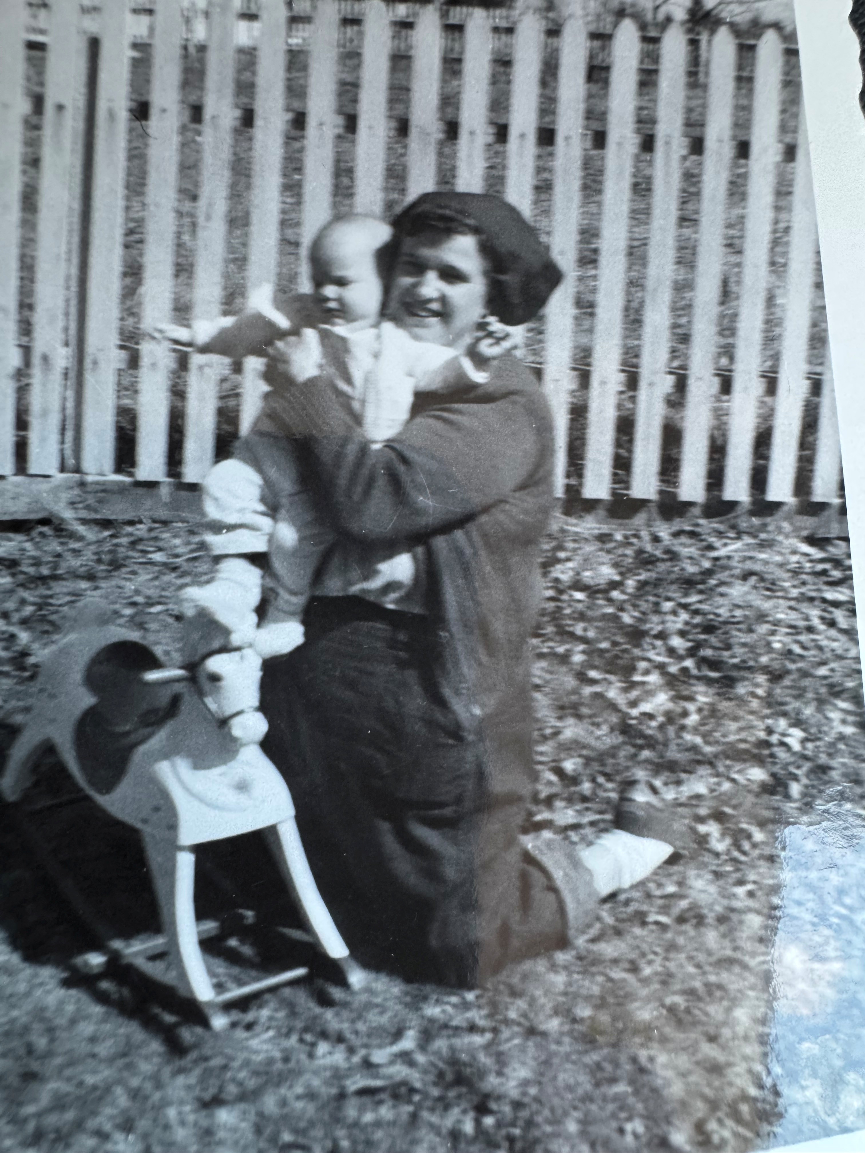 Black and white photo of grandmother holding baby.