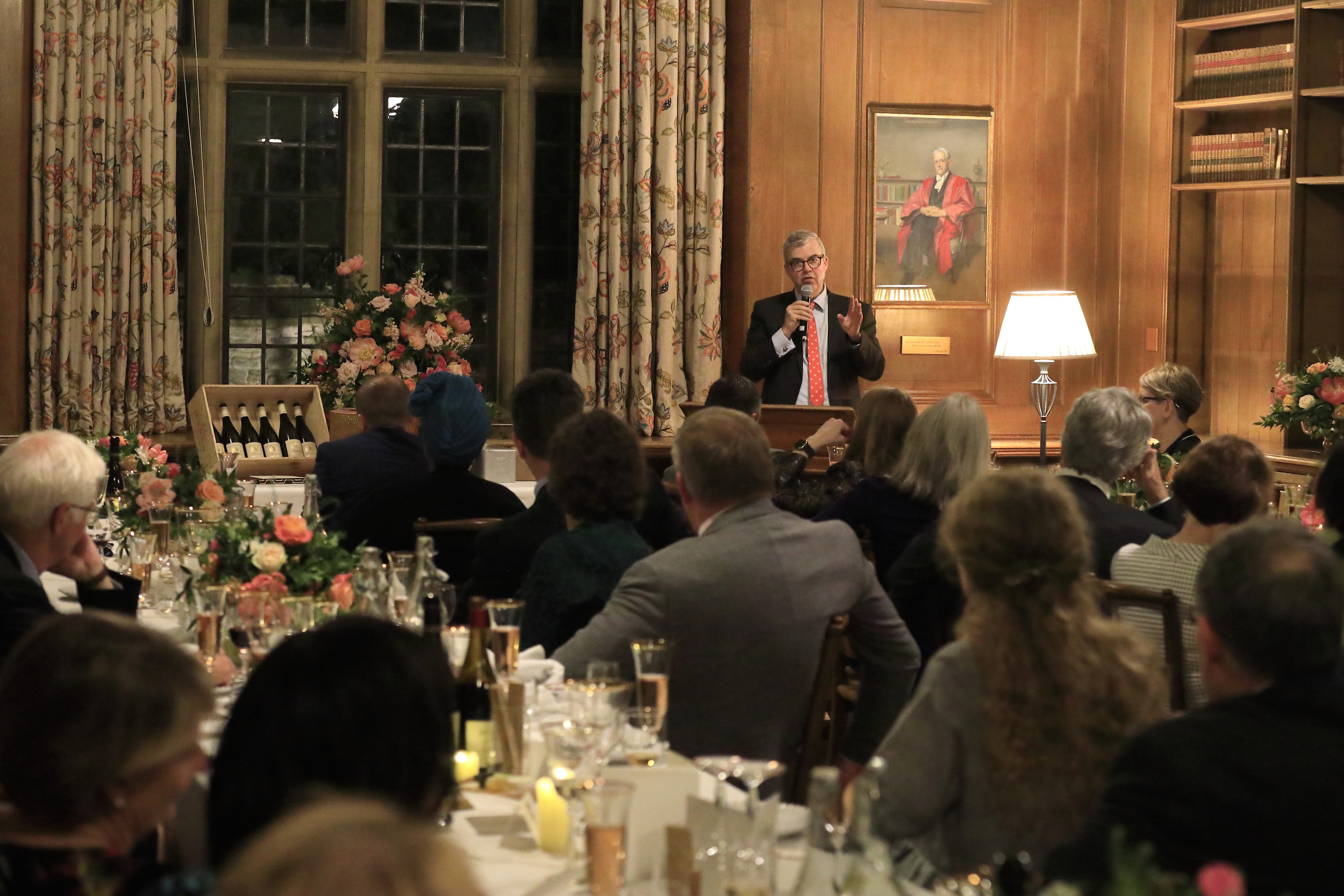 View of a speaker during a formal dinner in the Rhodes House Beit Room.