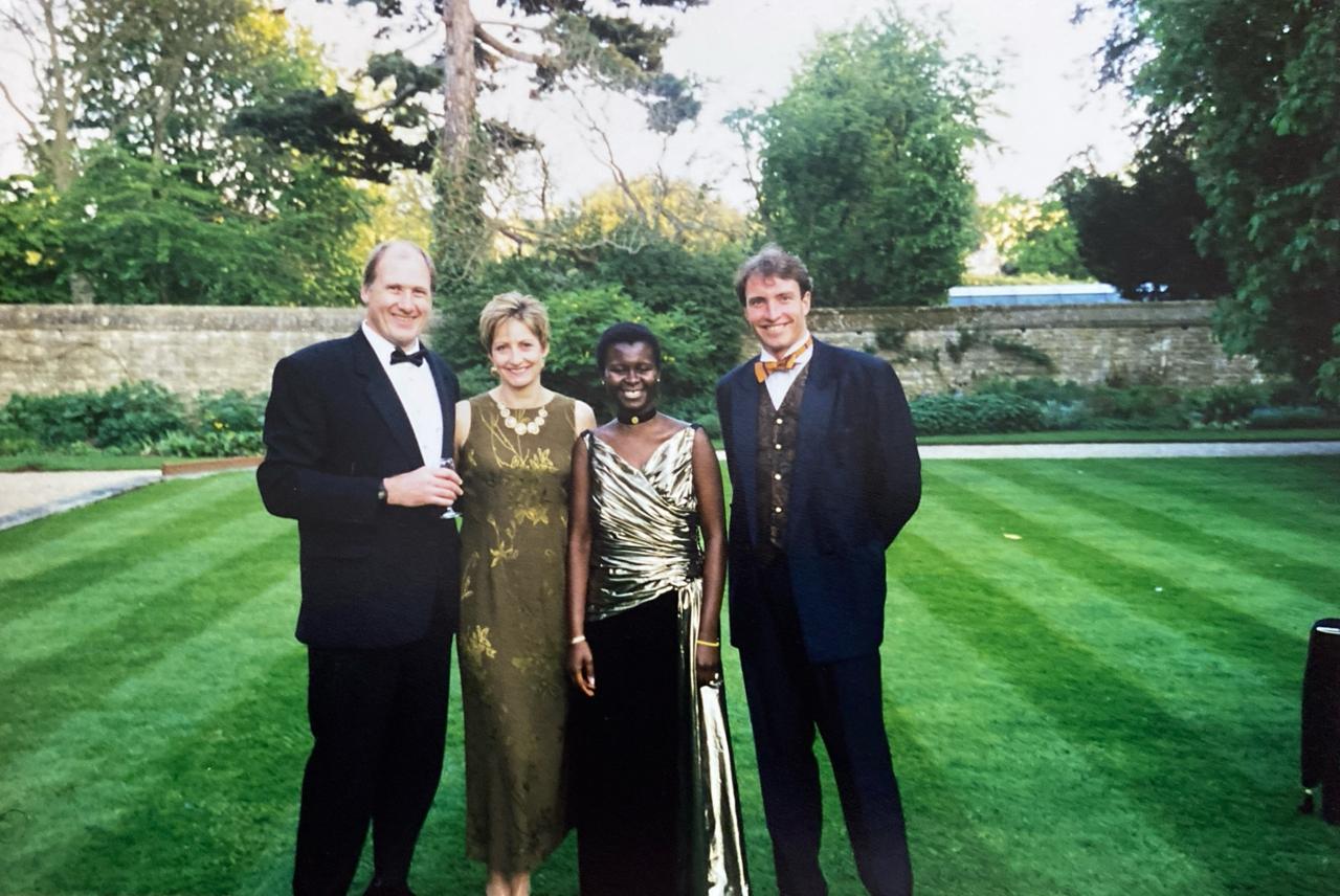 Rachel in a gold dress in the Rhodes House garden with friends