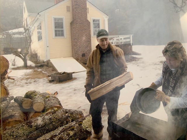 A picture of Joseph holding a block of maple wood 