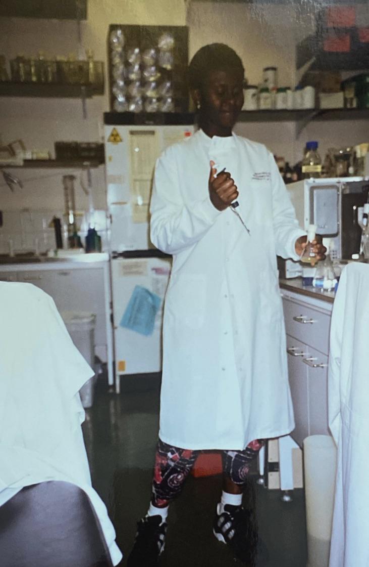 Rachel stood in a white lab coat holding a syringe