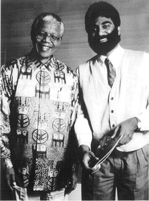 A black-and-white picture of Kumi with Nelson Mandela