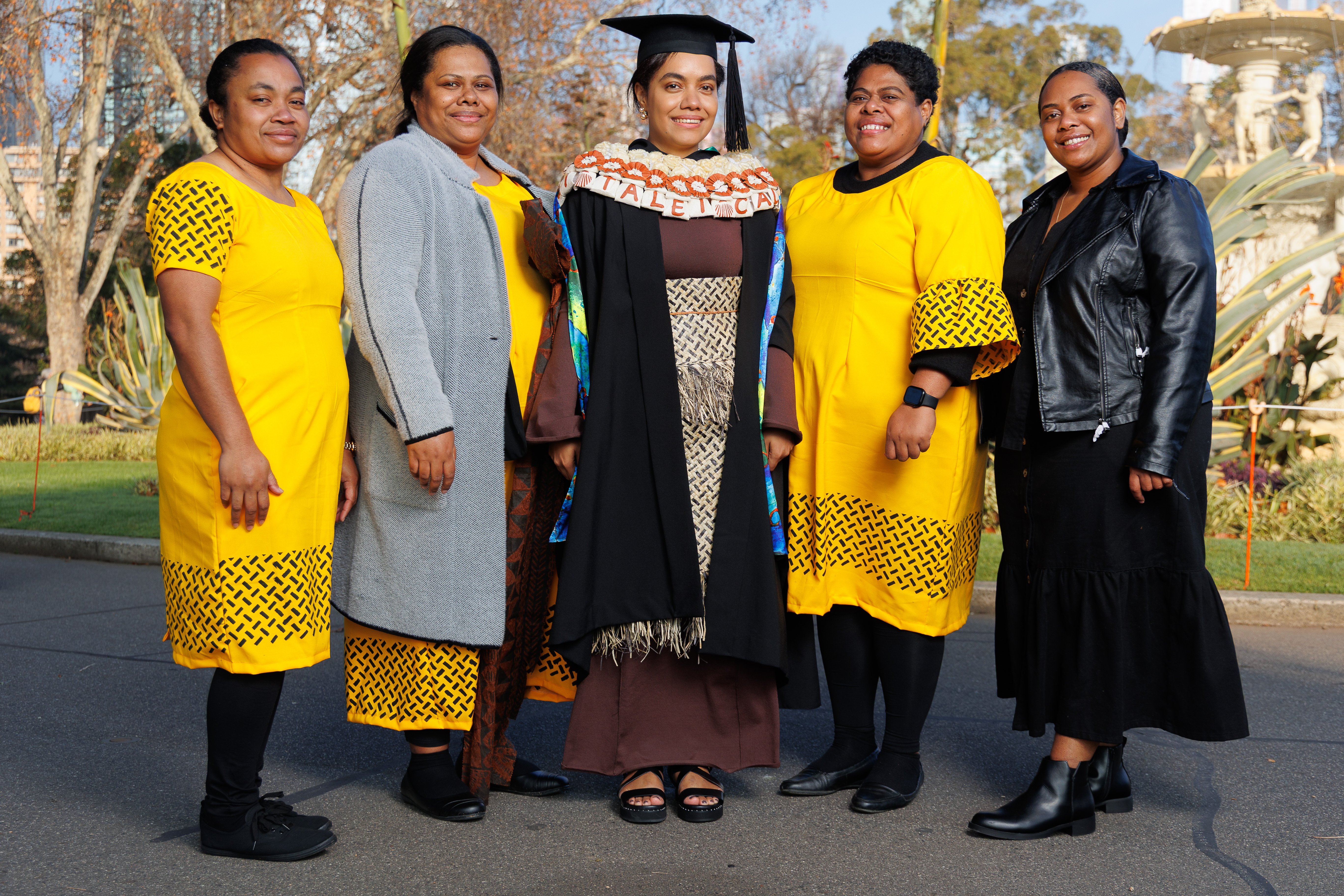 Talei and 4 others standing in a row at graduation