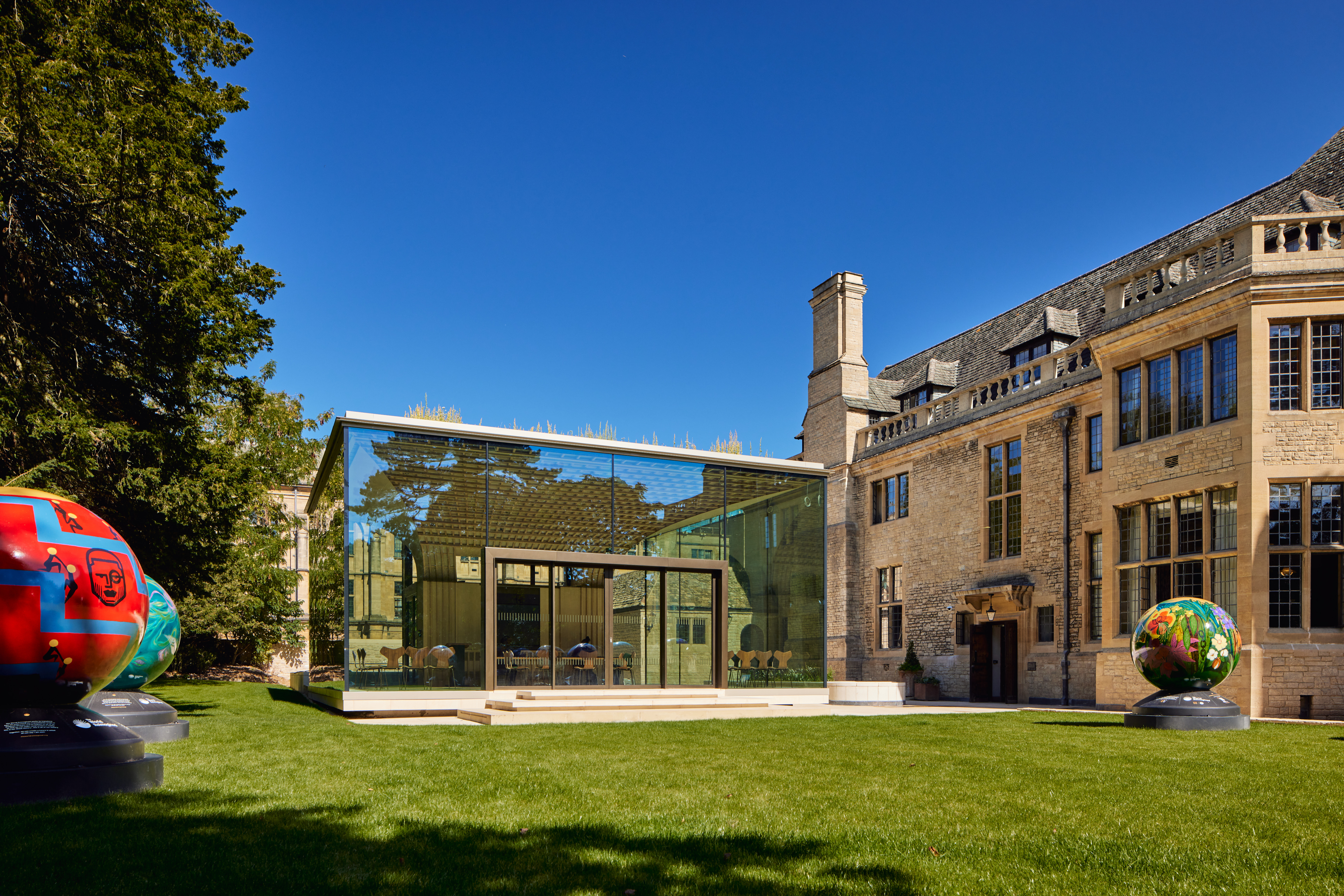 The Glass Pavilion at Rhodes House against a bright, blue sky.