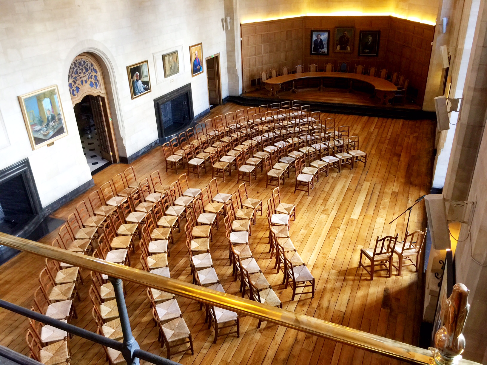 Rhodes House McCall MacBain Hall set up for a meeting with 120 chairs in an arch layout facing the bay window.