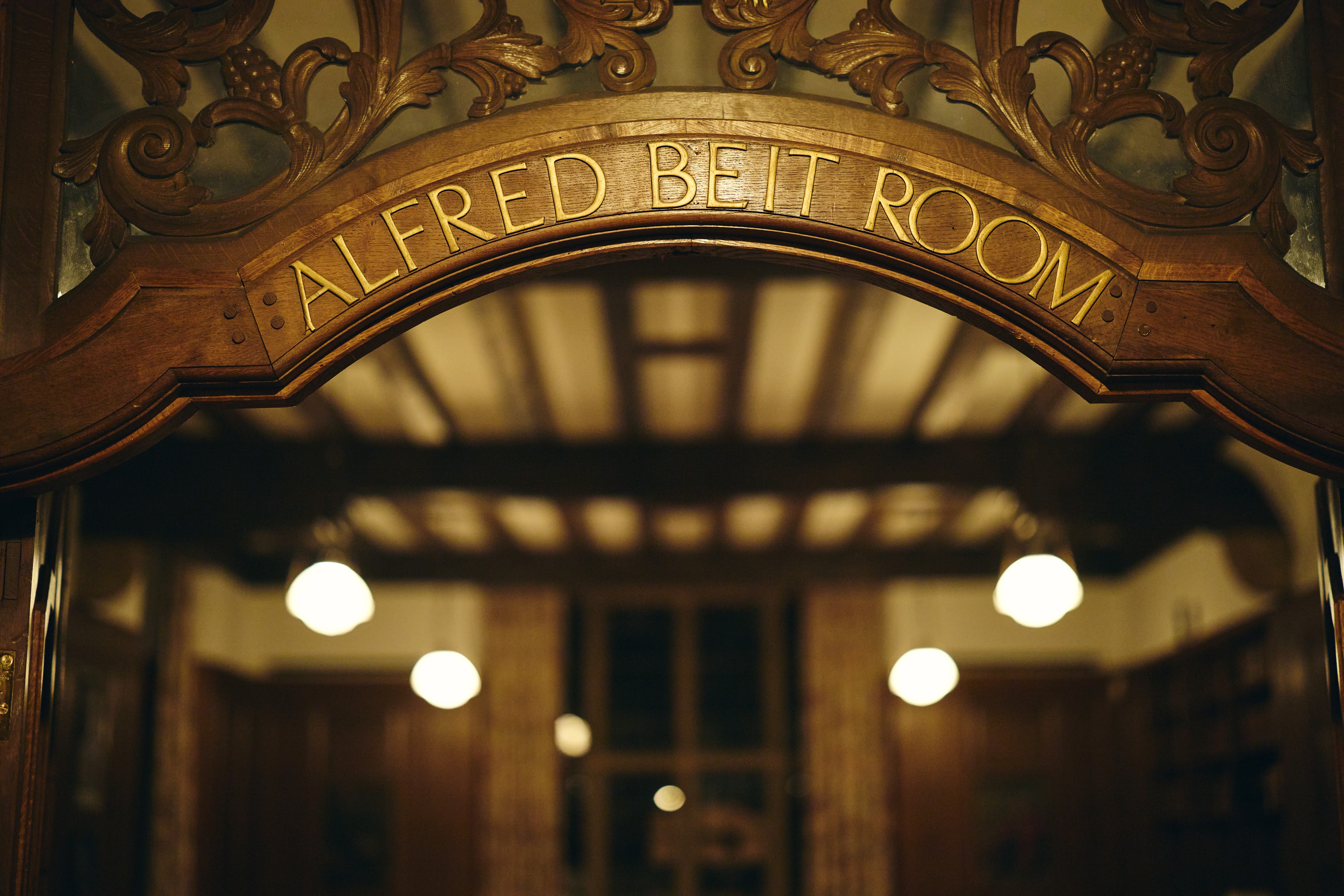 Engraved room name in arch above Rhodes House Beit Room door.
