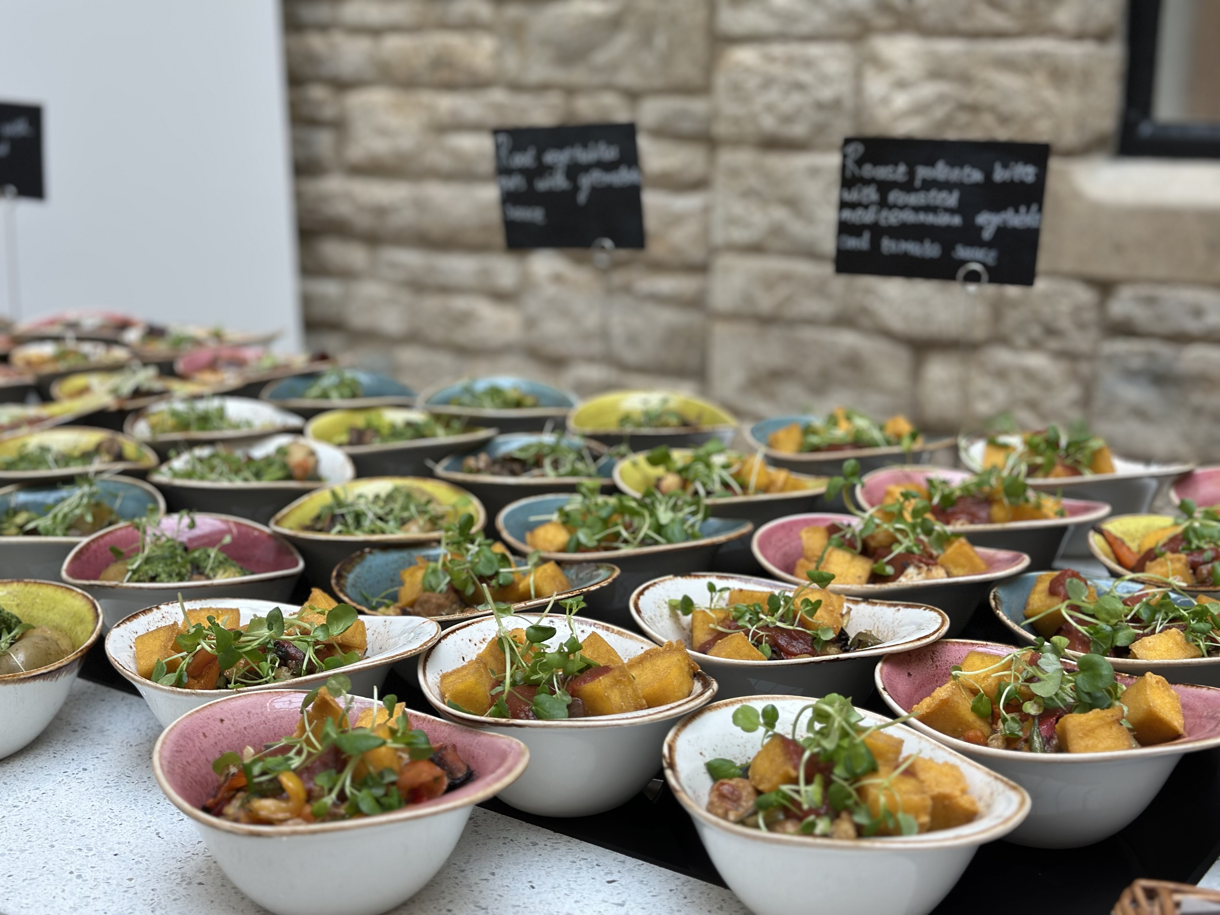 Bowl food set out for a standing delegate lunch.
