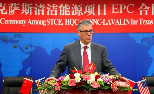 The picture shows Eric at a conference in China with flowers in front of the podium 