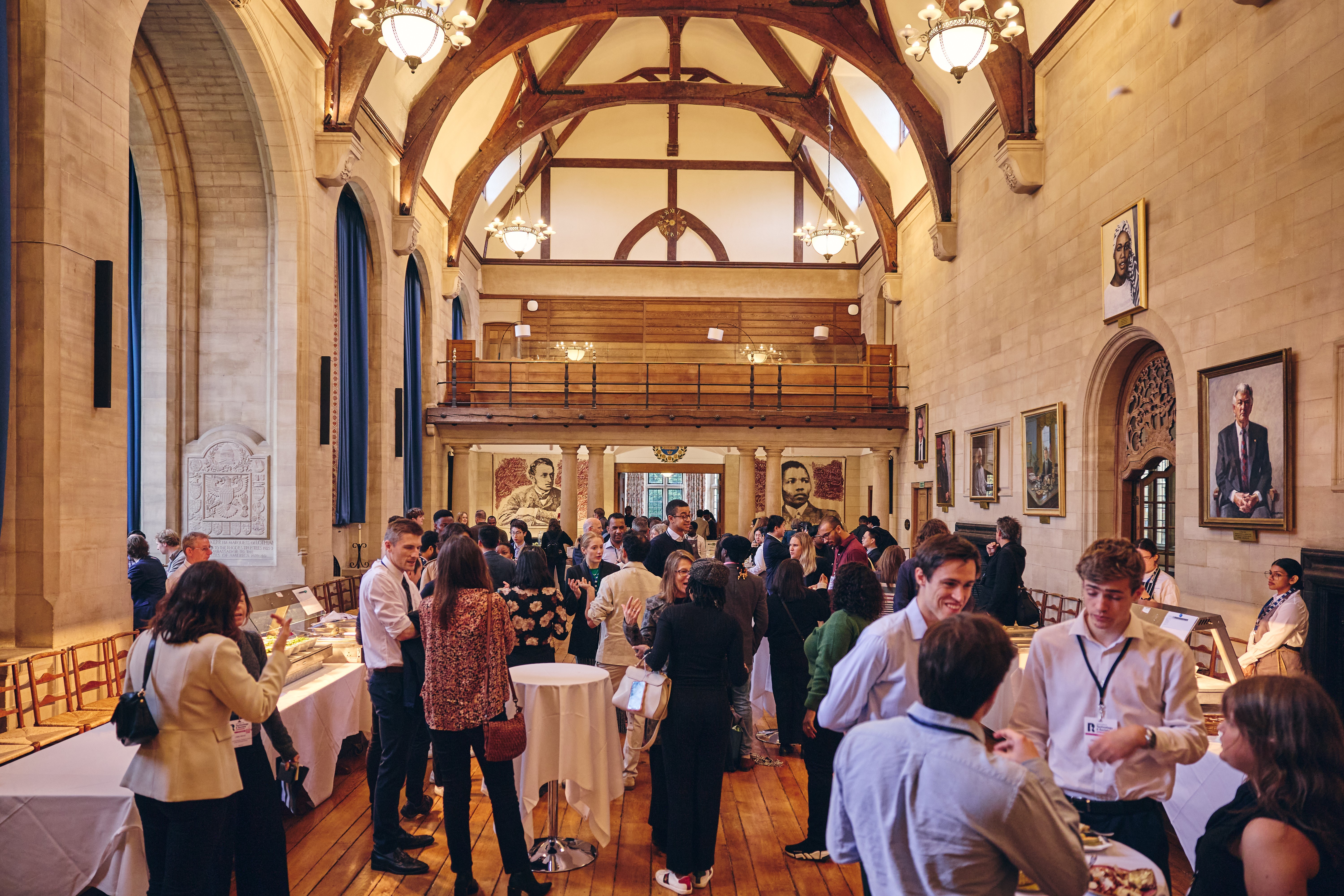Drinks reception in Rhodes House McCall MacBain Hall with guests standing and mingling