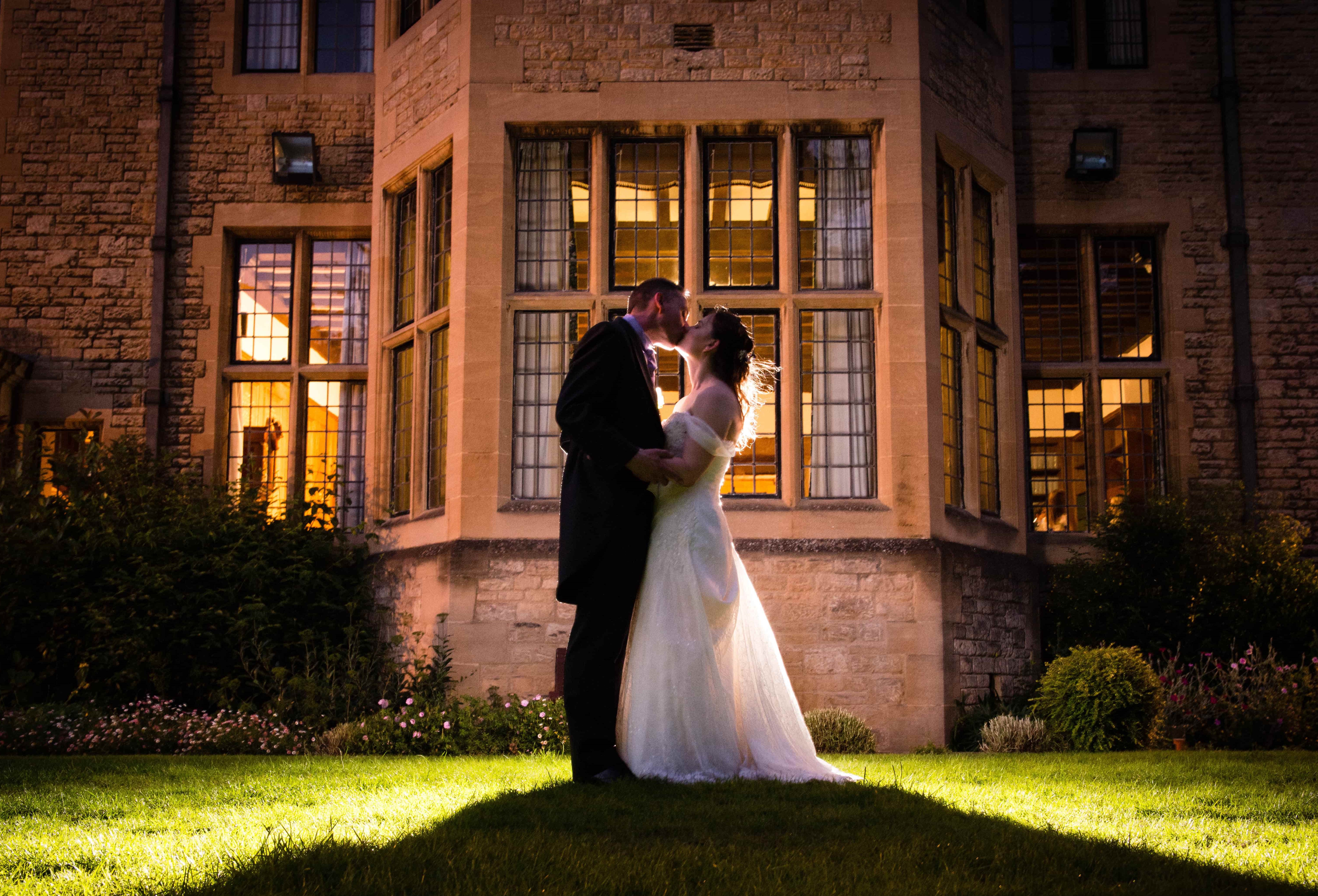 Wedding Couple Kissing at Night Outside the Rhodes House Bay Window