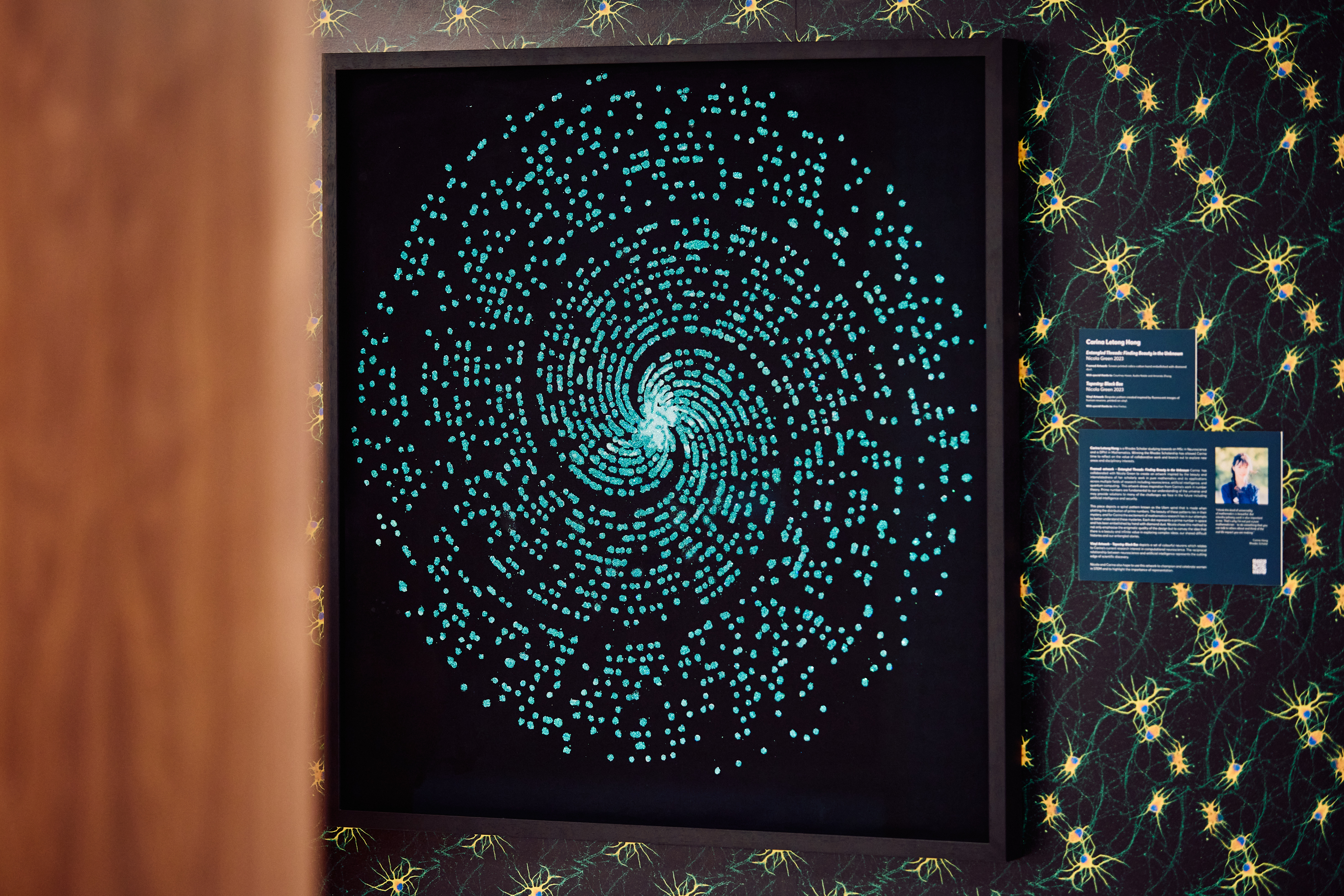 An artwork featuring a blue sparkling spiral contrasted on a black background