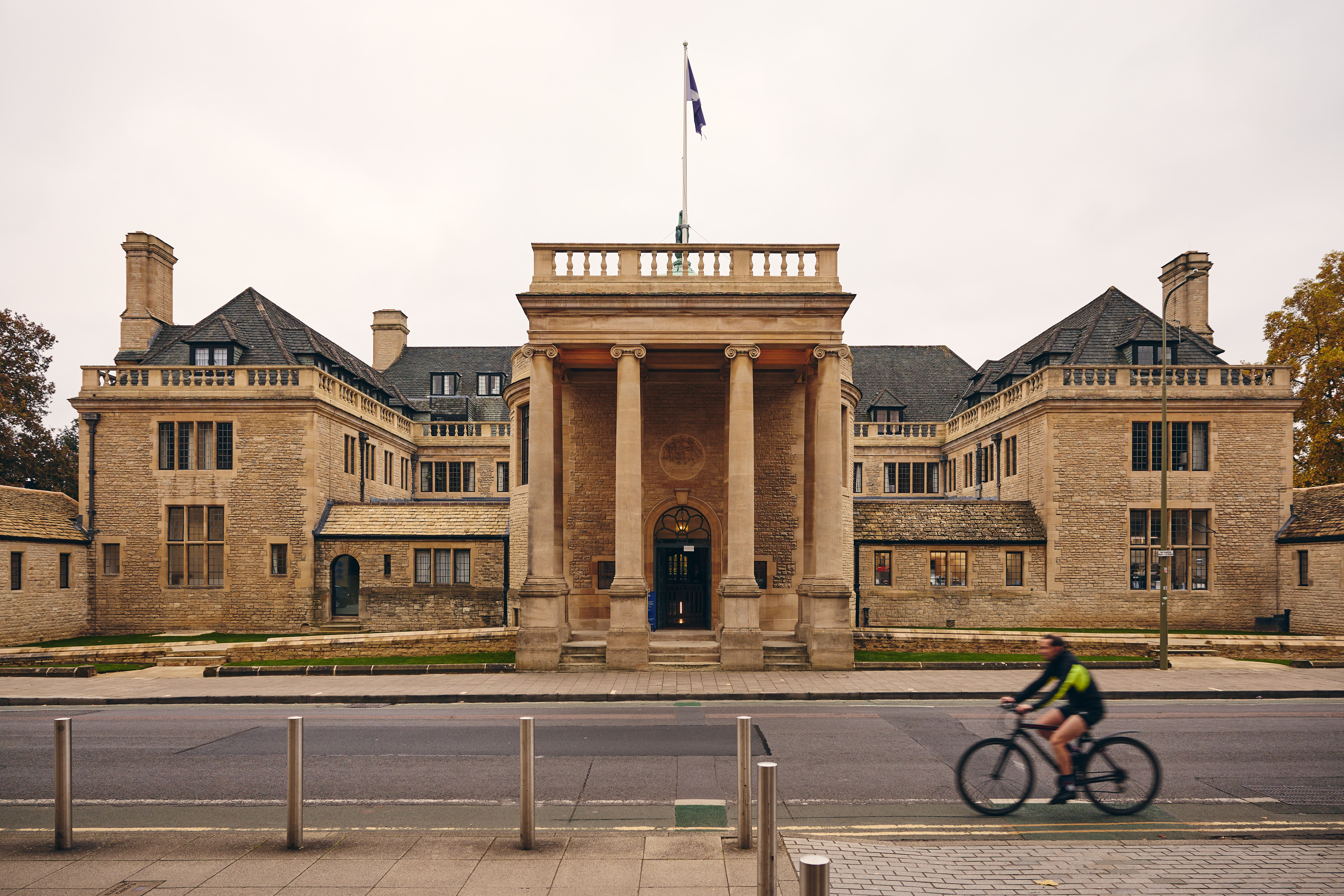 Rhodes House with a bike passing