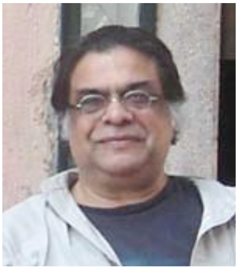 A picture of Jahar wearing round glasses and white hair on the sides.