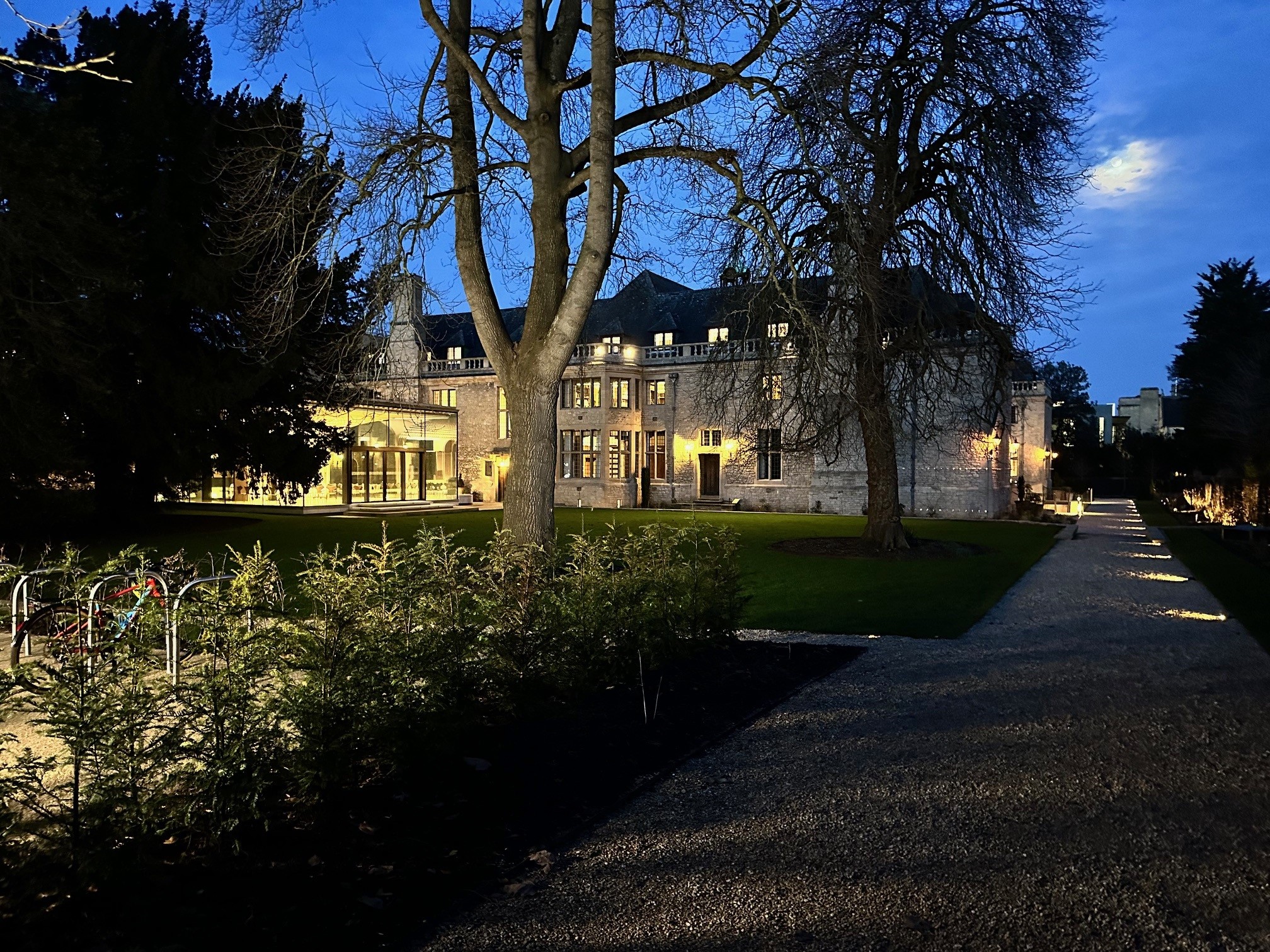 Rhodes House Glass Pavilion And Garden In the Evening with some bike racks in the foreground.