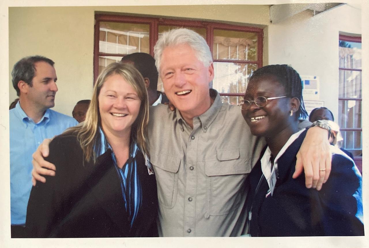 Bill Clinton with his arm around Rachel and another woman. All smiling.