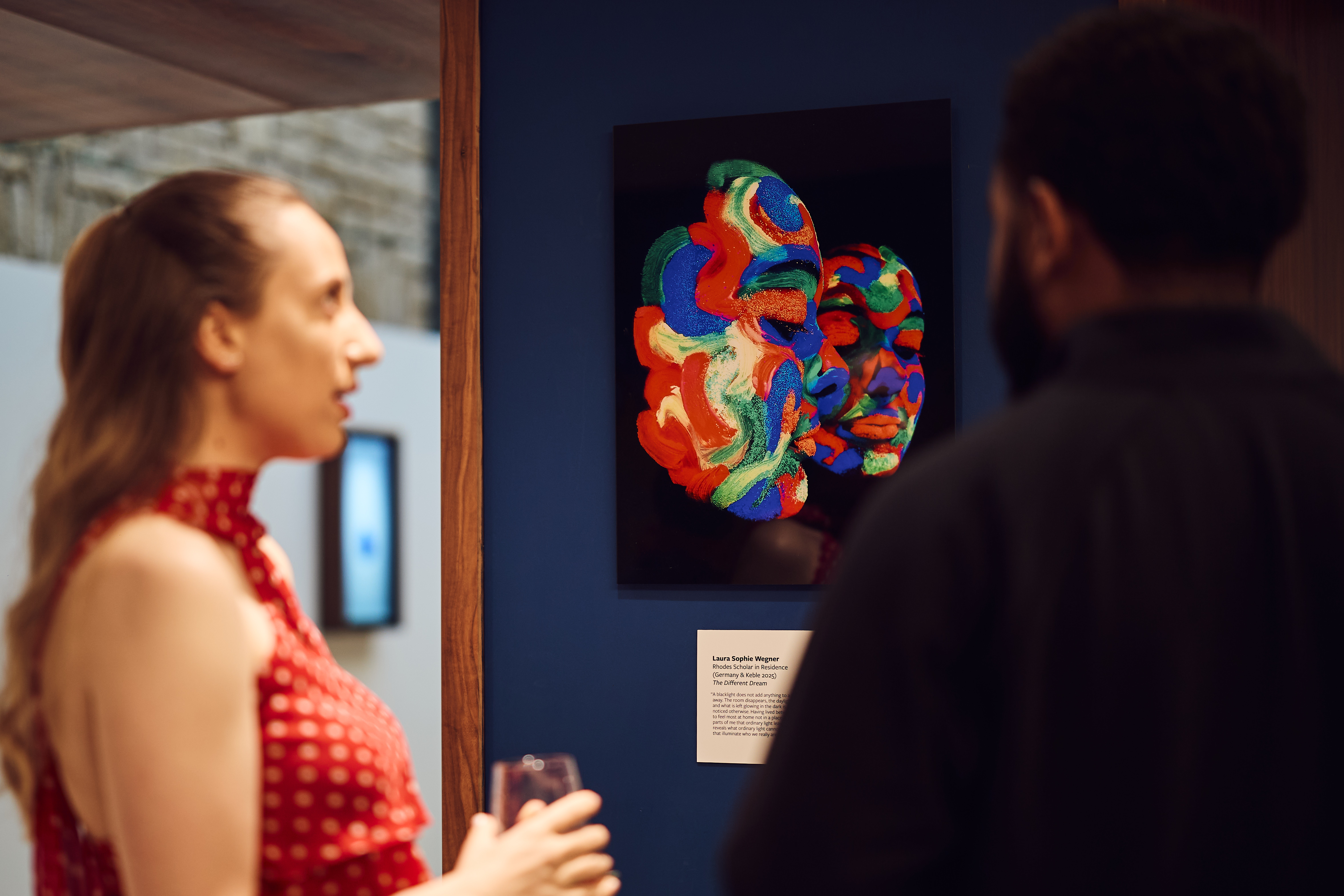 Someone looking at a colourful artwork