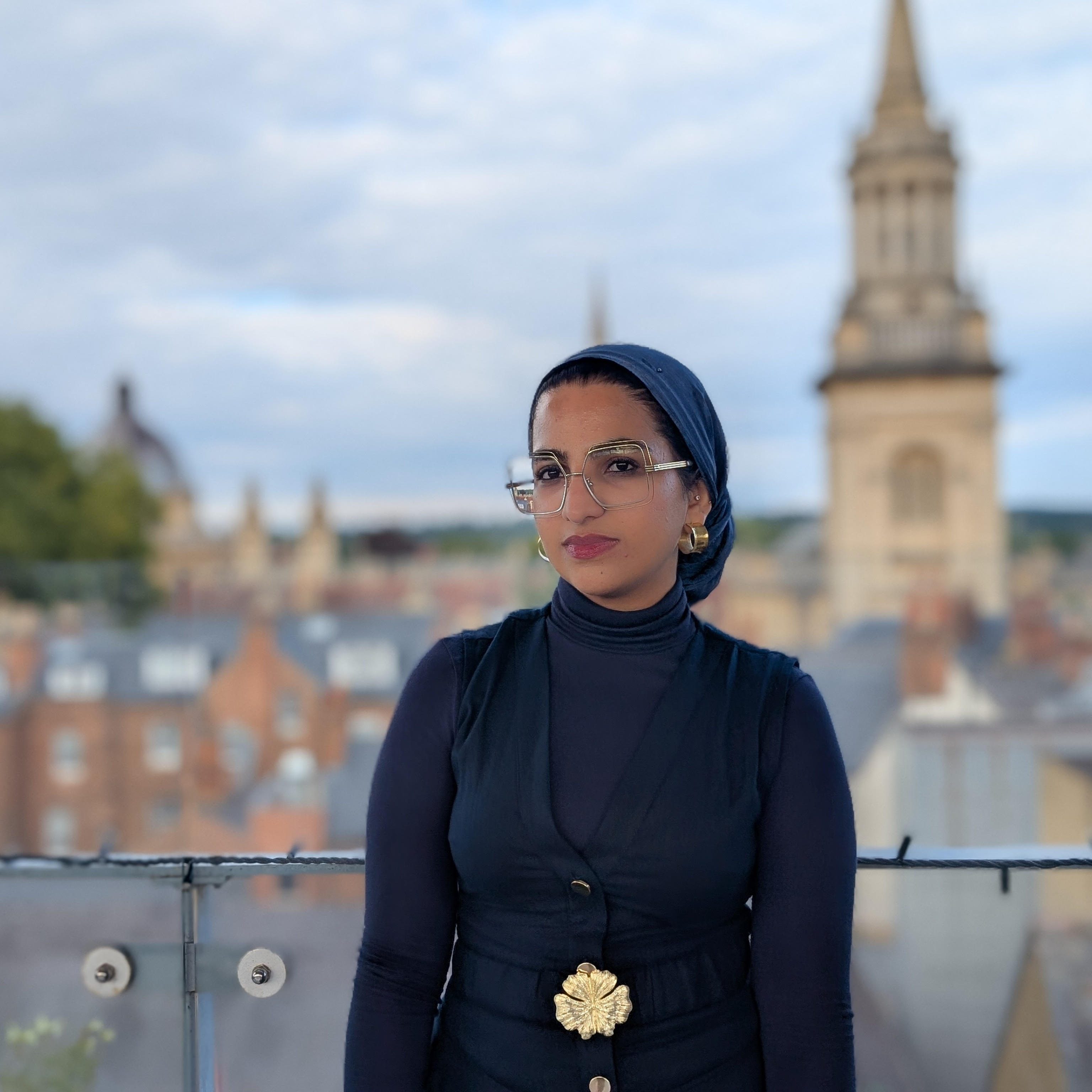 A headshot of Azania in front of a tall building in Oxford