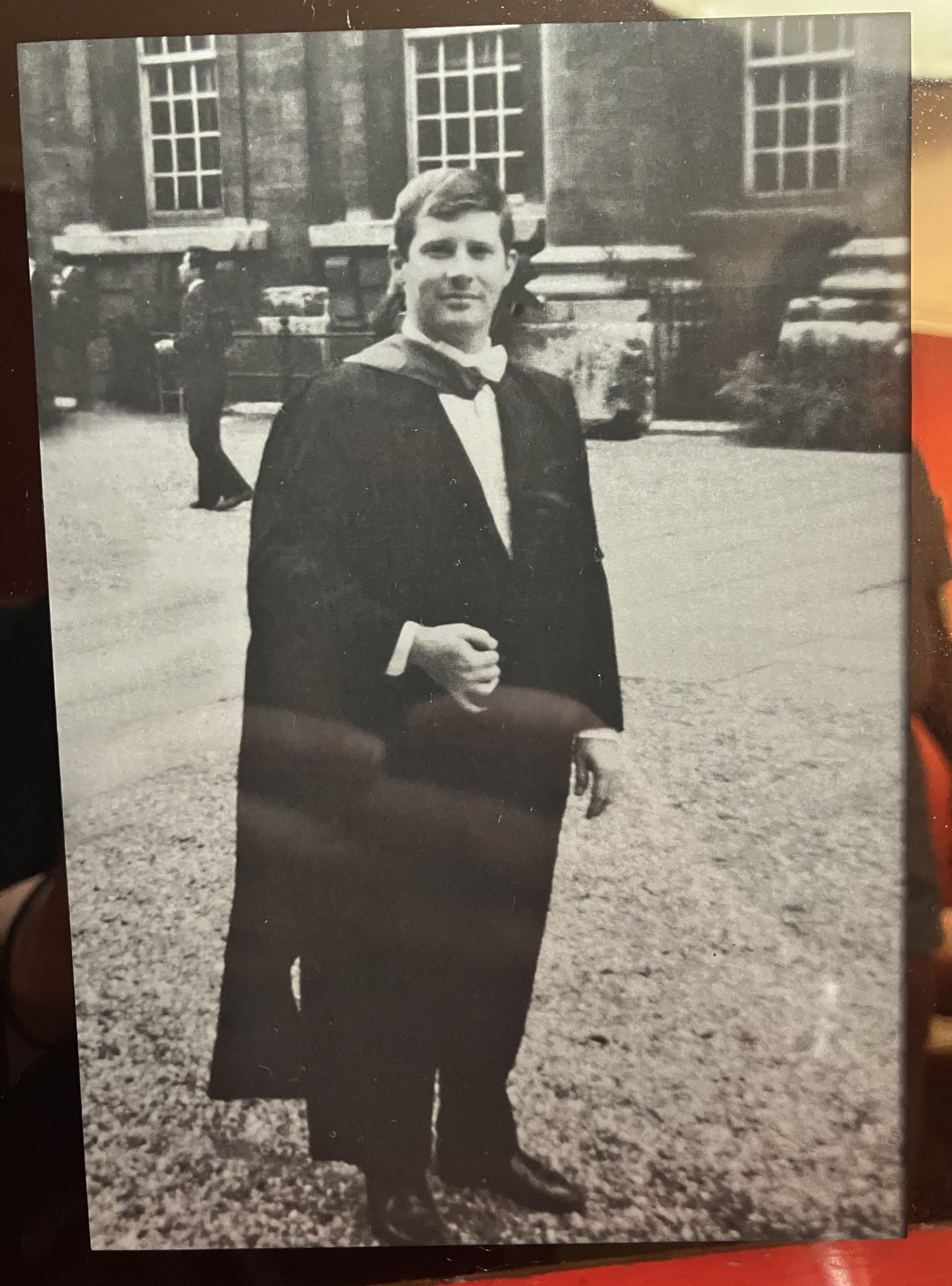 A black-and-white picture of Bob wearing a gown 