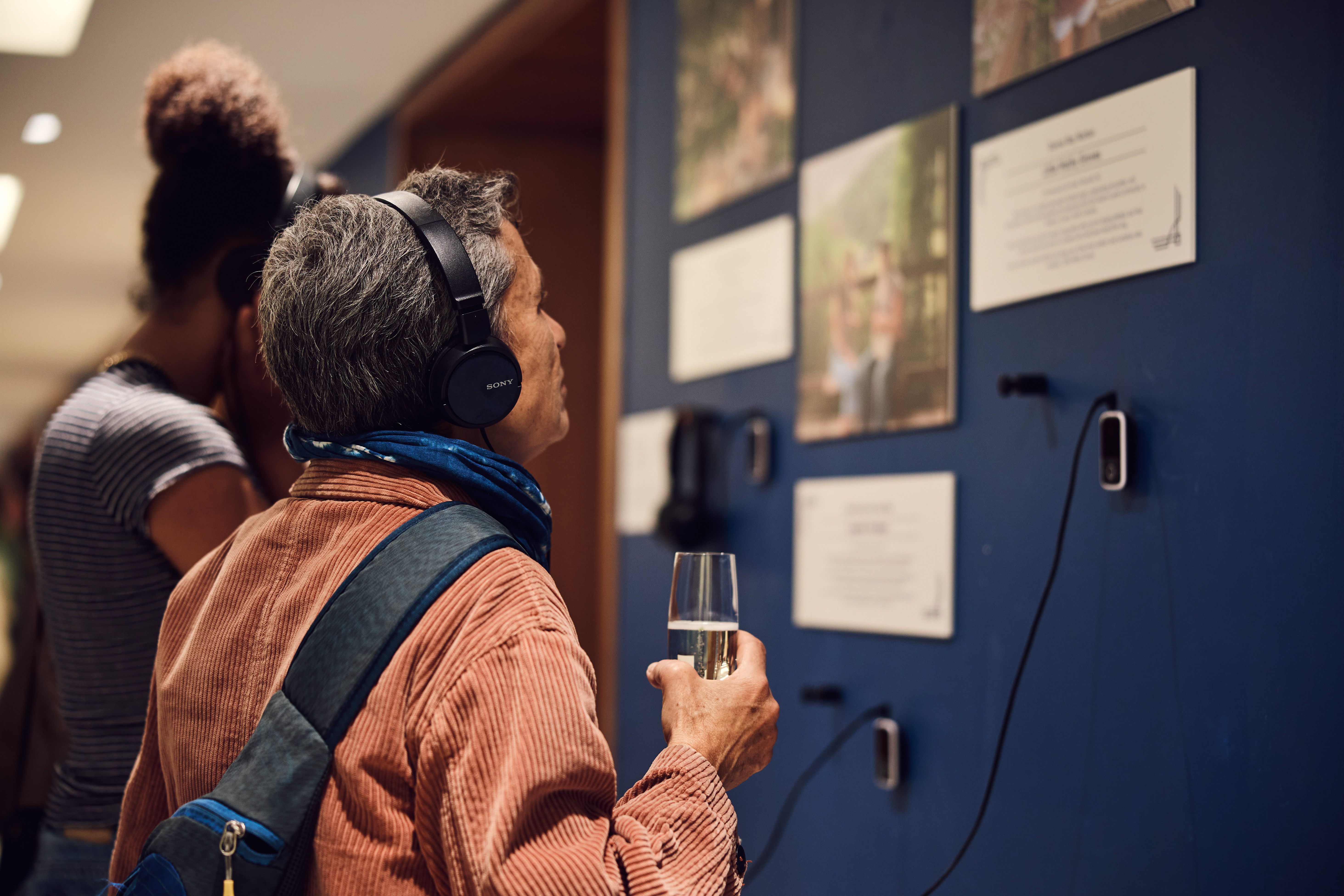 Someone listening to music in front of art