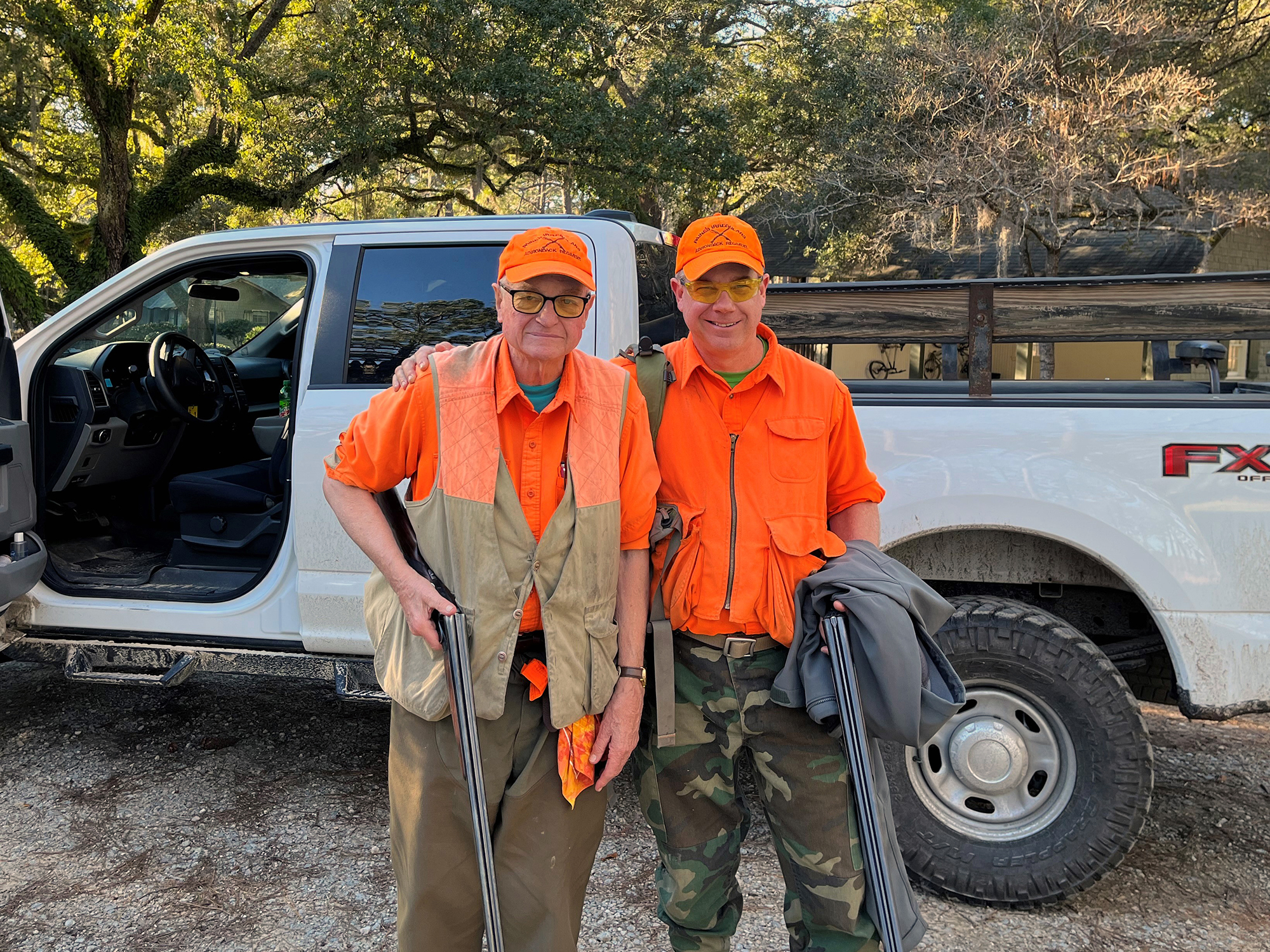 Peter stood to the left, with son to his right, both wearing fluorescent orange.
