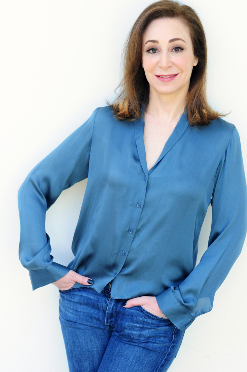 A recent picture of Jessica in a satin blue shirt and jeans.