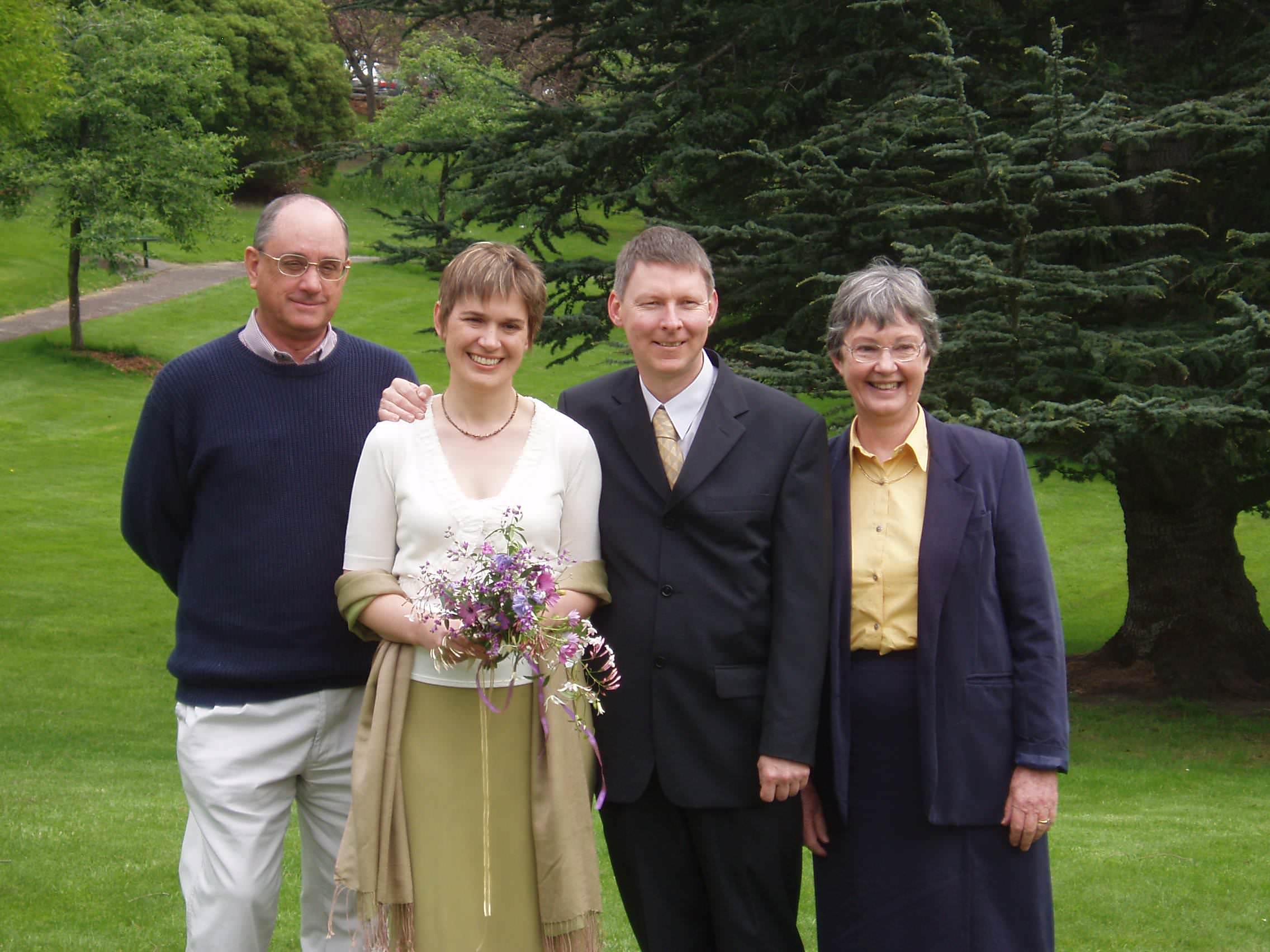 The picture shows Elle in a wedding dress along with her husband in a suit. Her parents stand on either side of the couple.