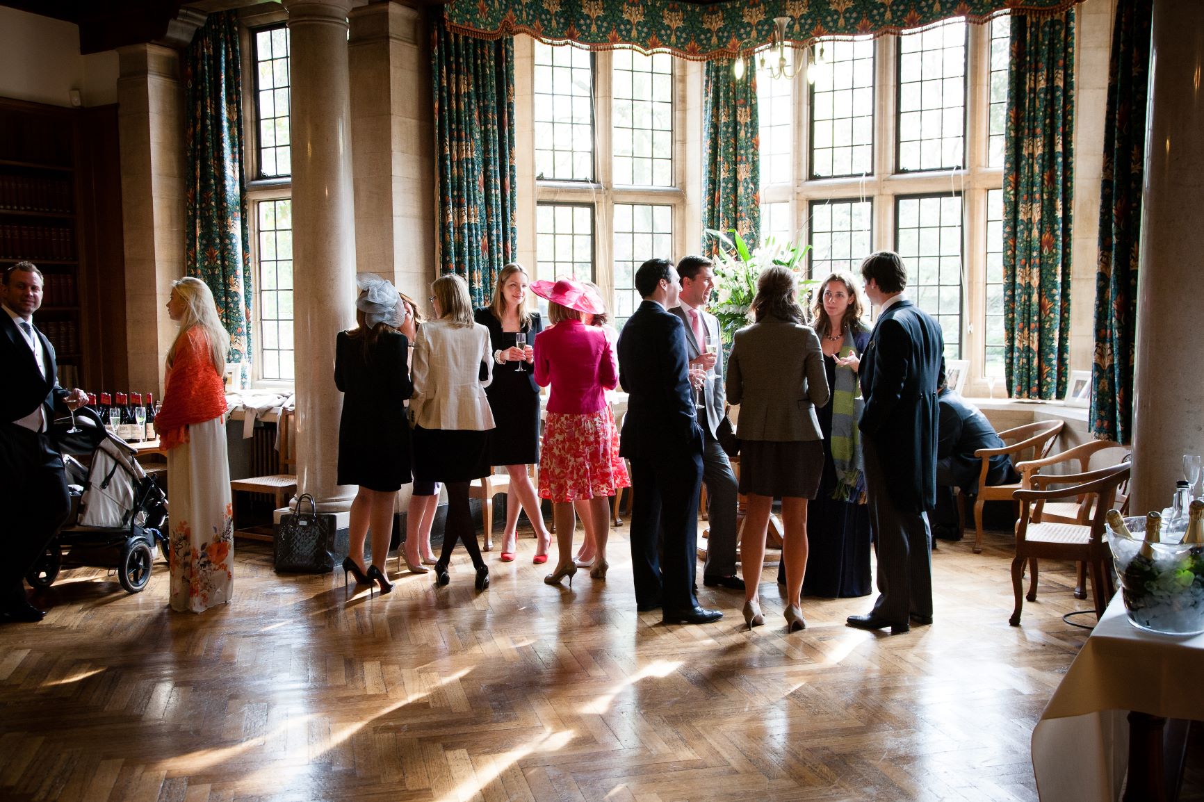 Guests mingling at a drinks reception in the Rhodes House Reception Room