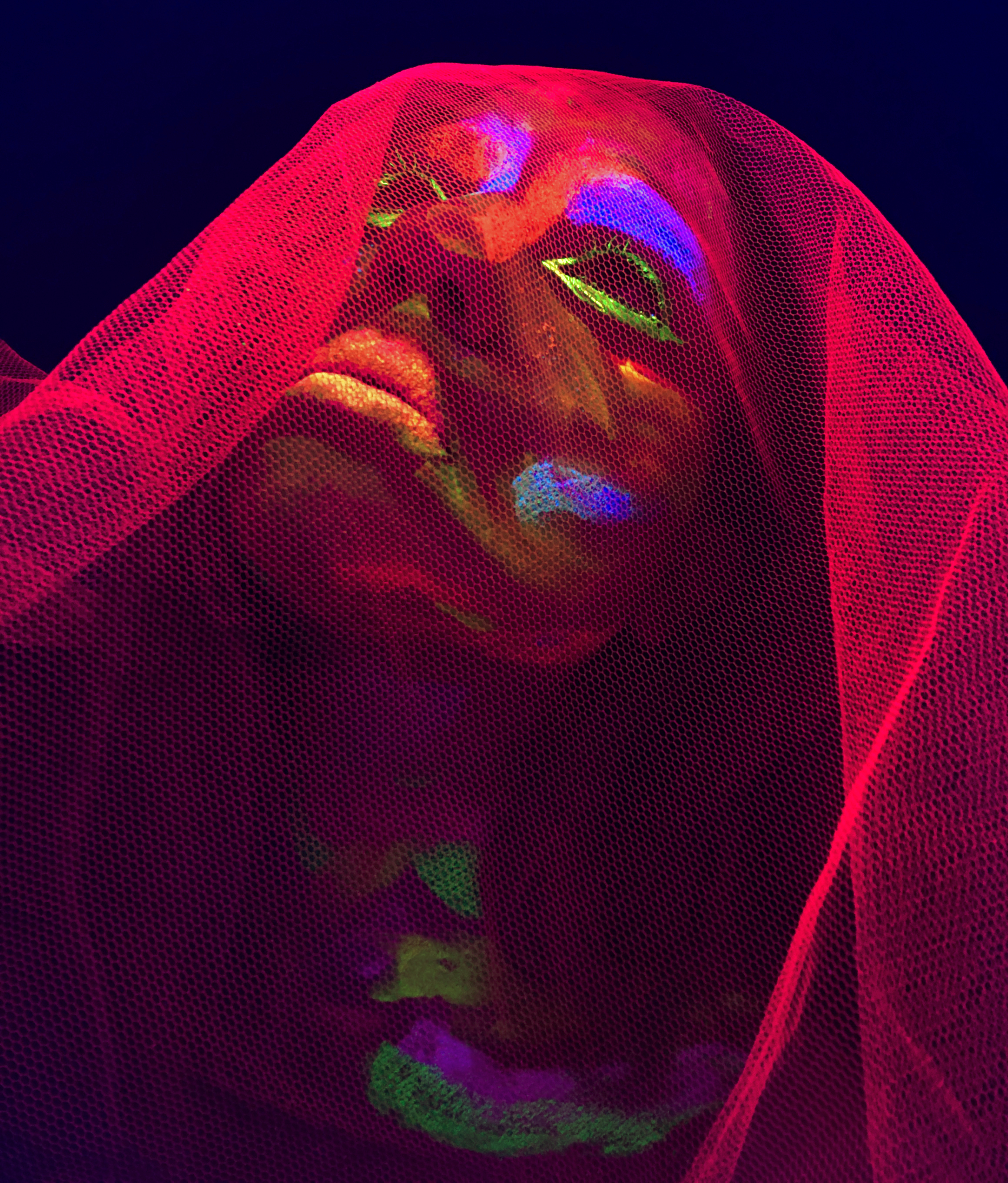 Laura with neon paint and gauze on her face