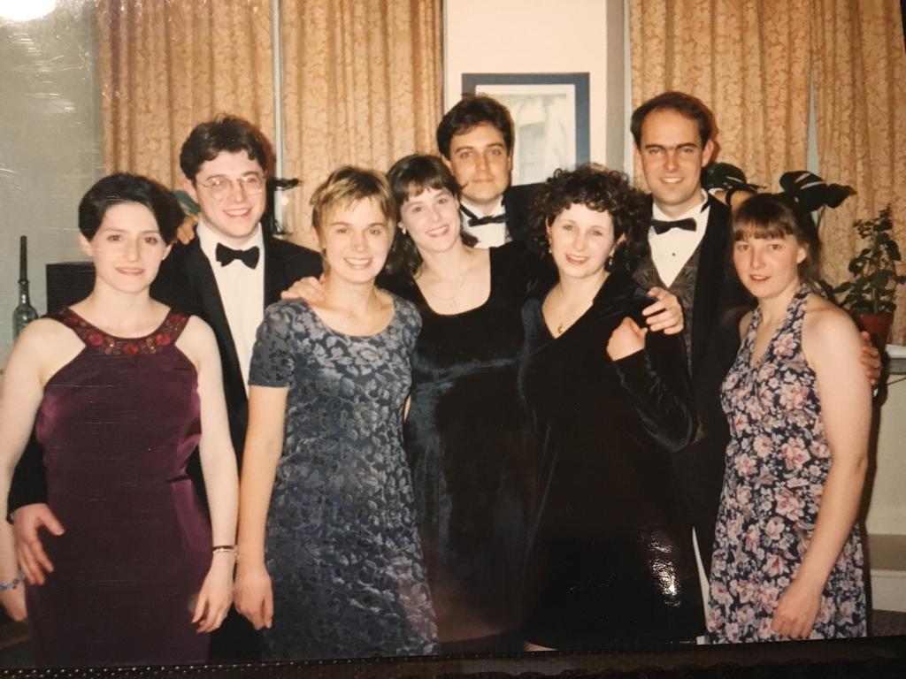 The picture shows a group of young students dressed in suits and dresses before a ball at Christ Church