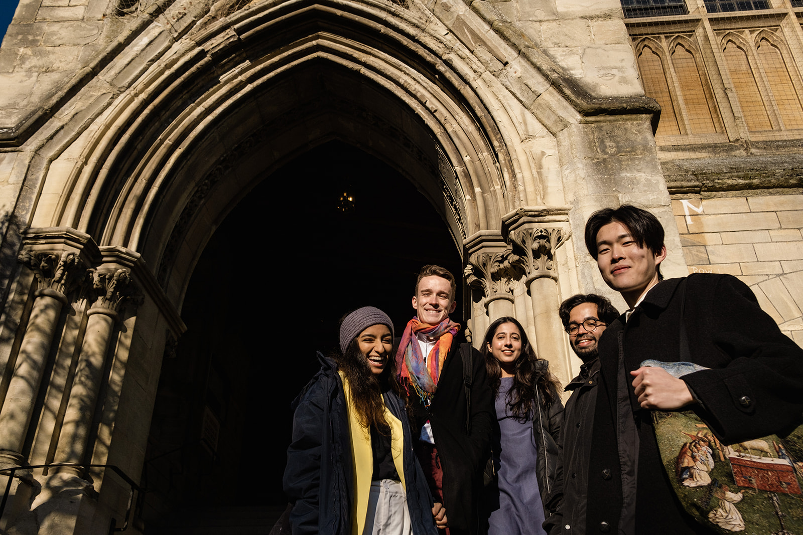 A group of Rhodes Scholars laughing and smiling at the camera.
