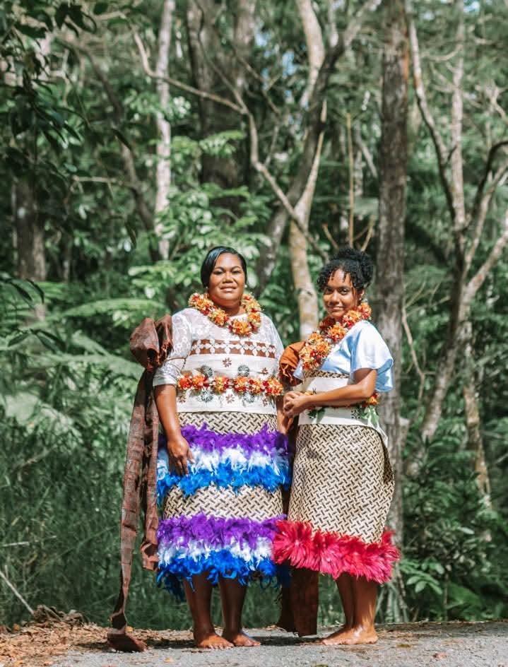 Talei standing next to another person in front of trees