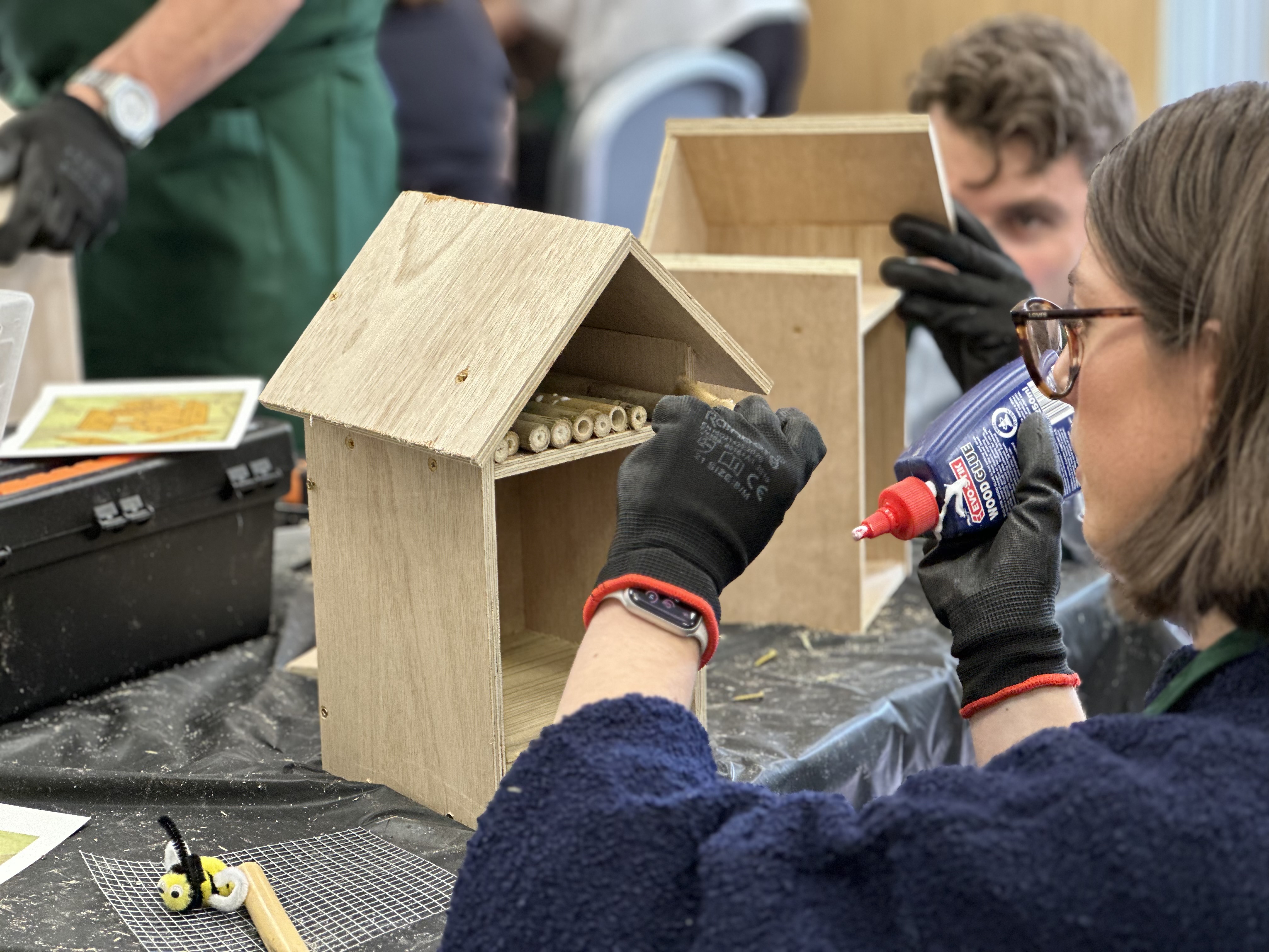 Delegate at a team building event creating a bee hotel.