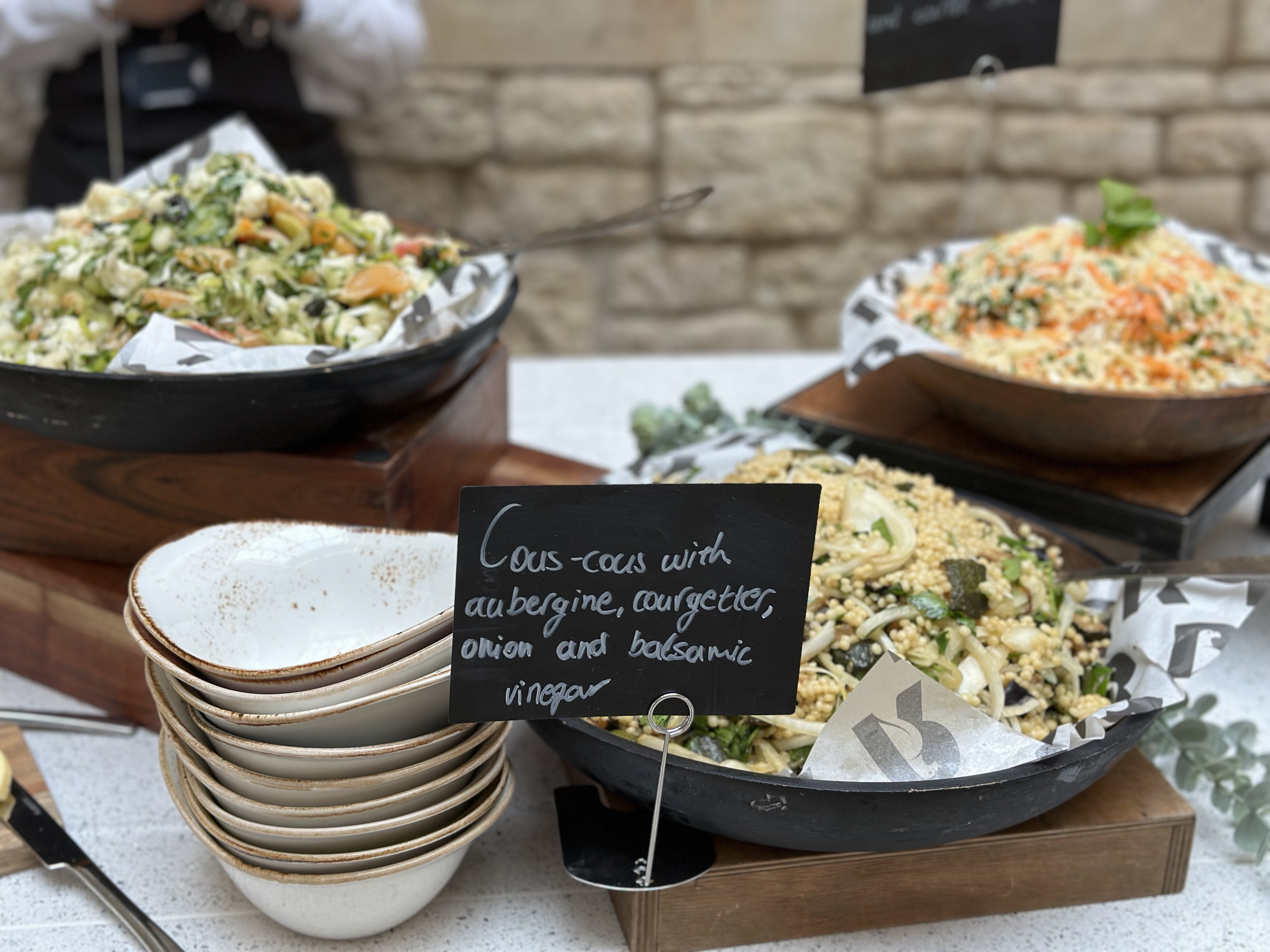 Close up of salads set out as part of a bowl food lunch. 