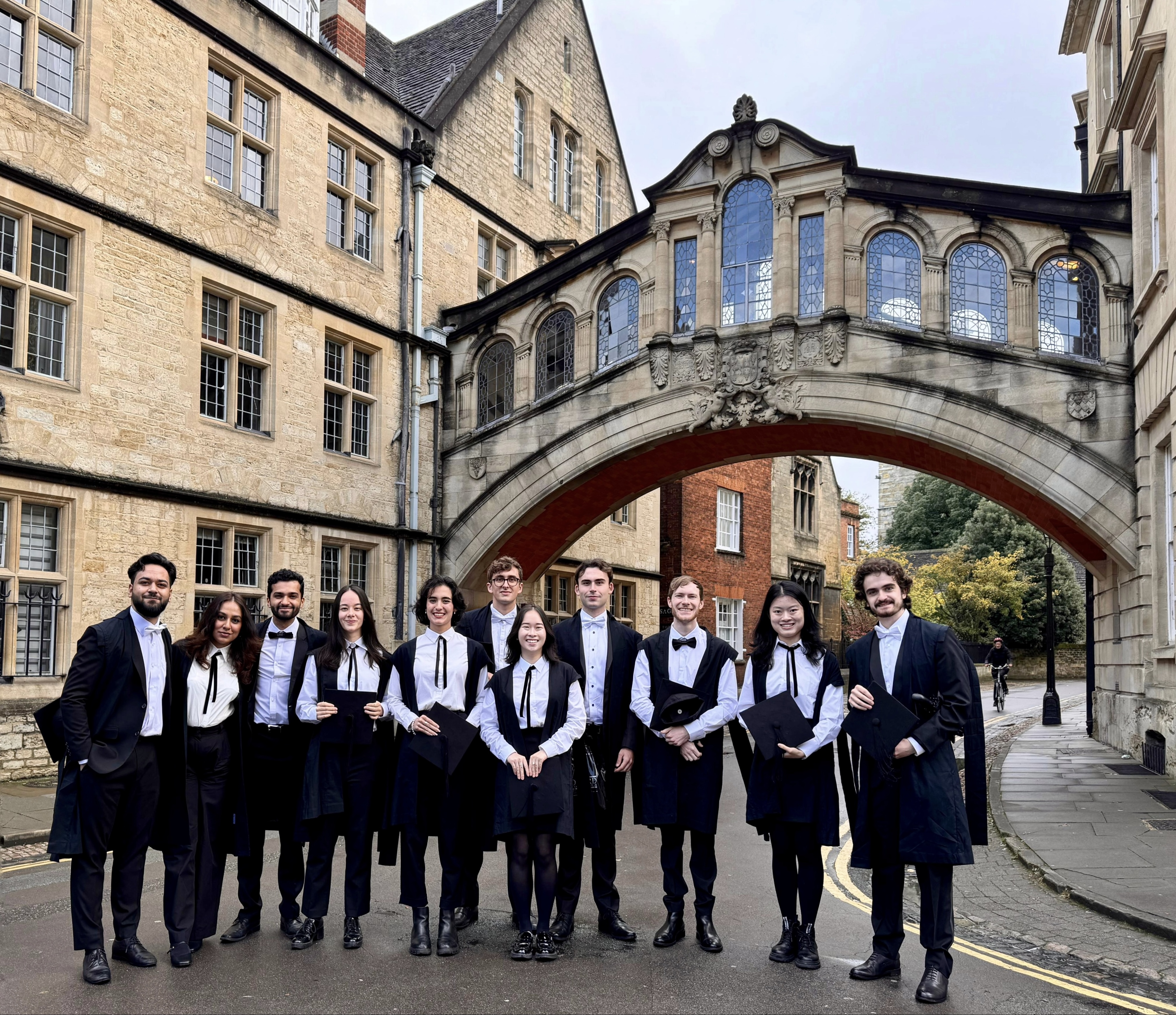 Anne and Scholars wearing sub fusc standing in front of the Bridge of Sighs