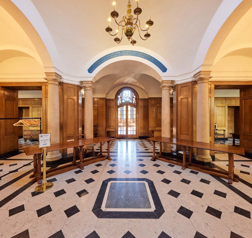 Parkin Vestibule with two registration tables and the entrance to McCall MacBain Hall in the background.