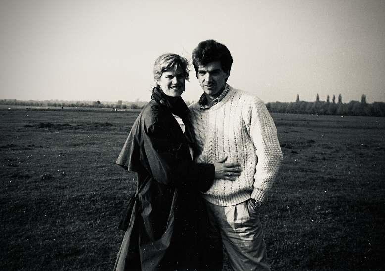 A black-and-white picture of Charles and Kris standing close together with Port Meadow in the background