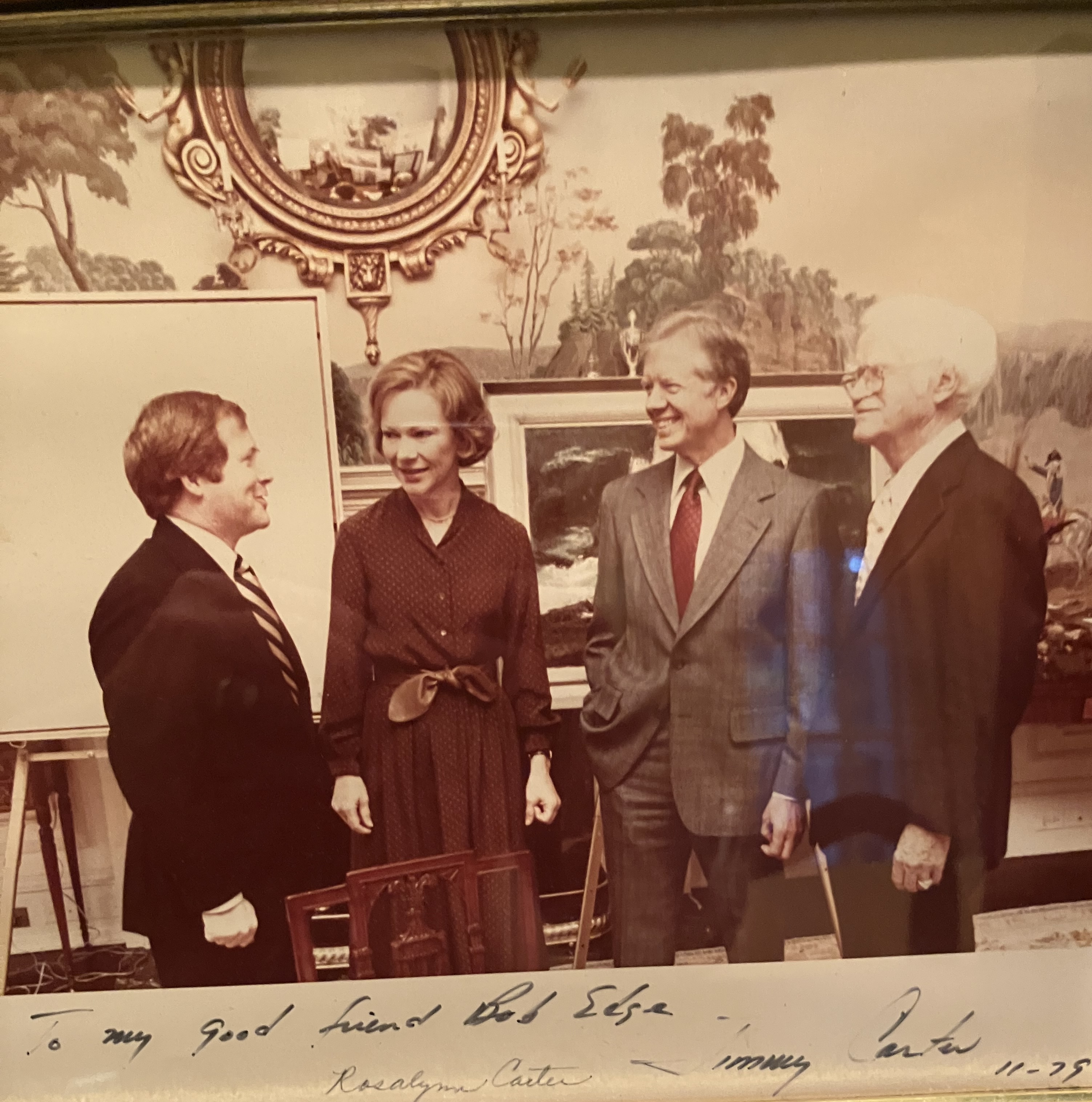 Bob with Rosalynn and Jimmy Carter and another man, dressed in formal attire and surrounded by nature paintings