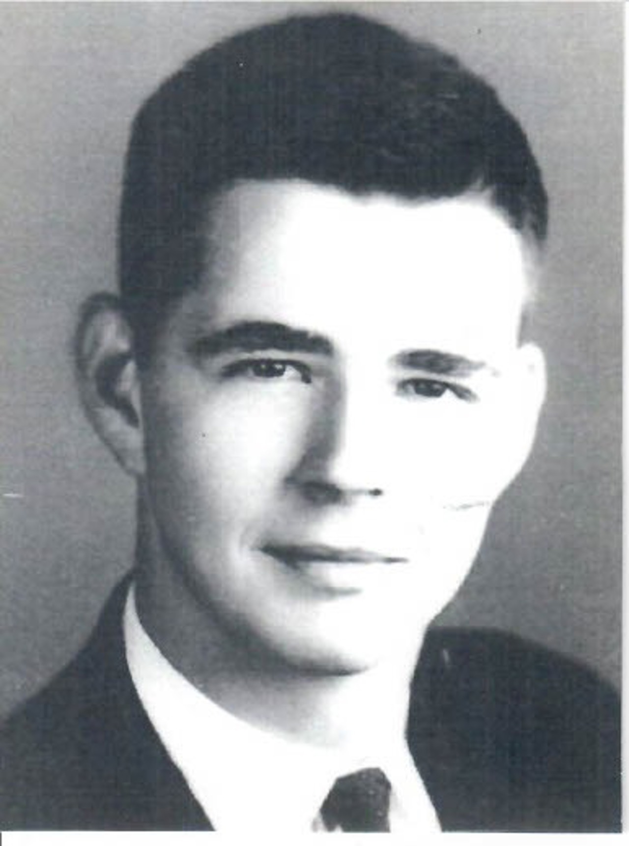 A black-and-white headshot of Norton