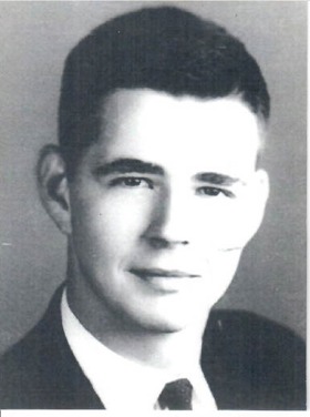A black-and-white headshot of Norton