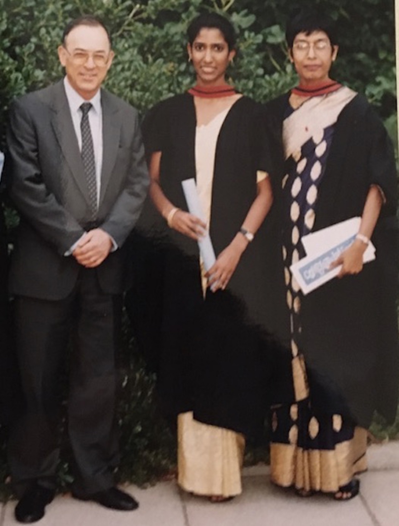 Ruanne stood in the middle of both her parents wearing a sari with her graduation certificate in hand.